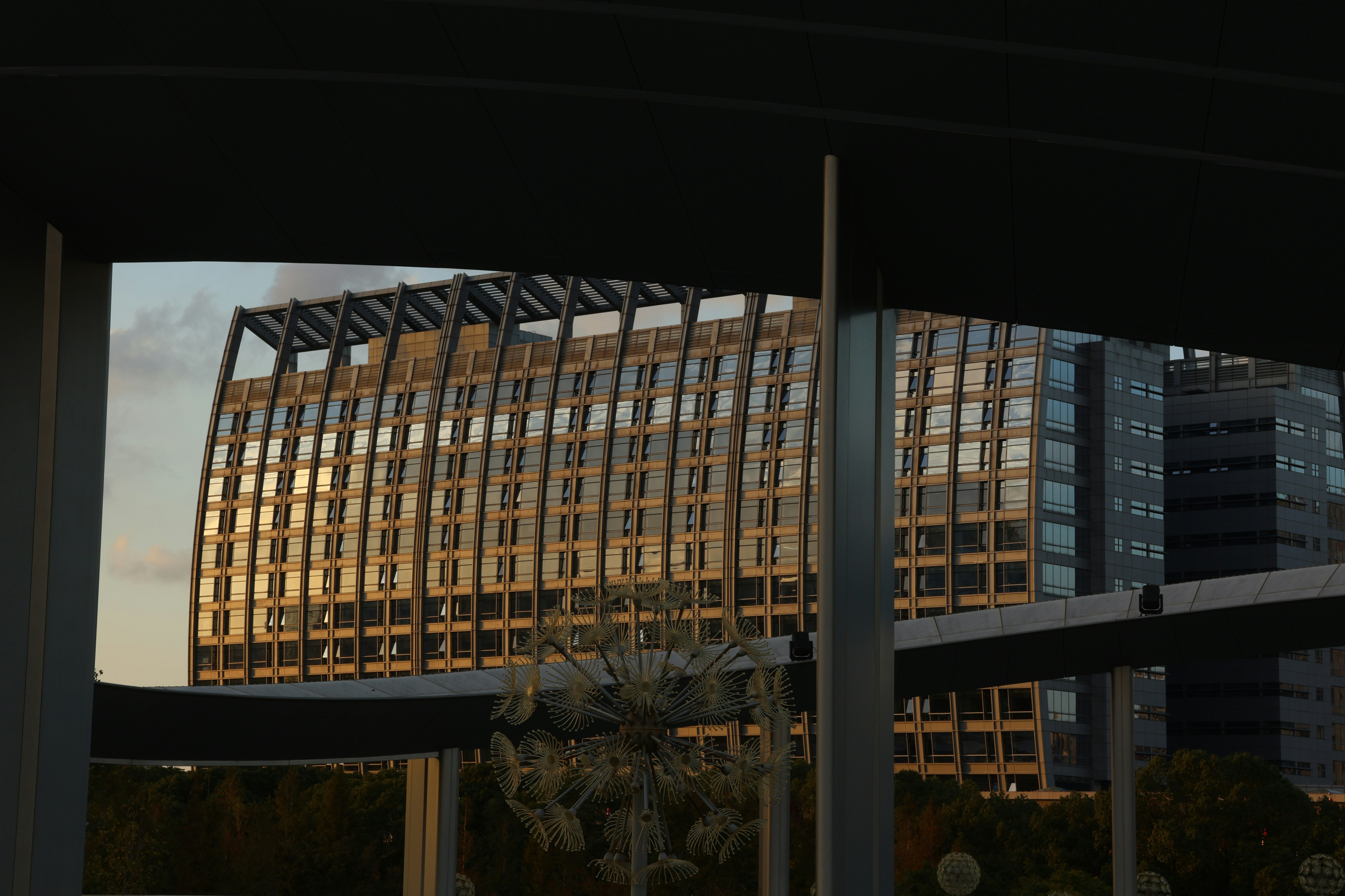 Modern office building with many windows at sunset.