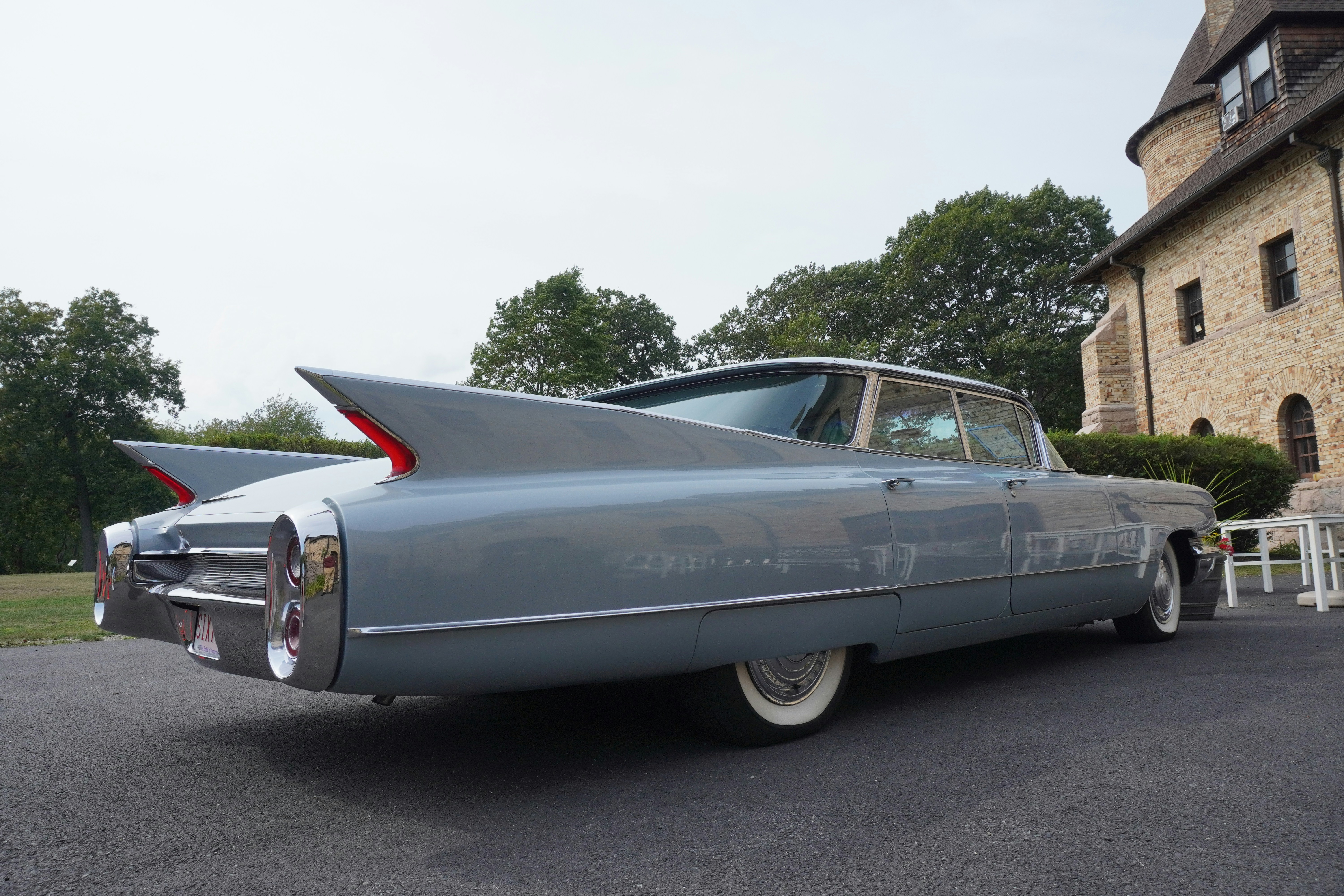 A classic light blue cadillac with tail fins.