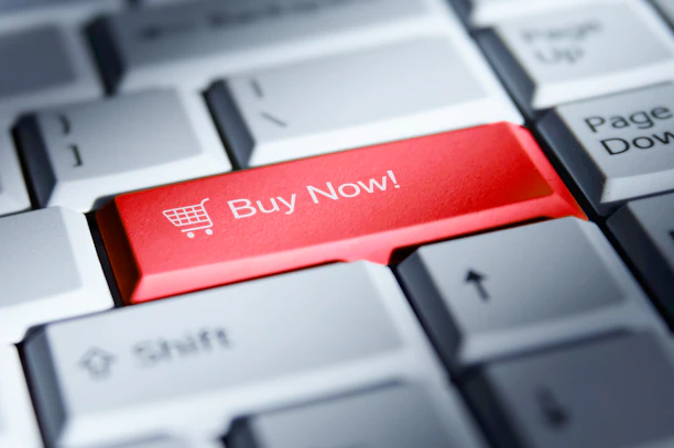 Red 'buy now!' button on a computer keyboard.