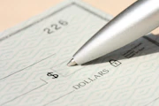 Pen poised over a check, ready to write