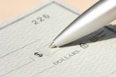 Pen poised over a check, ready to write.