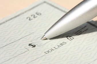 Pen poised over a check, ready to write