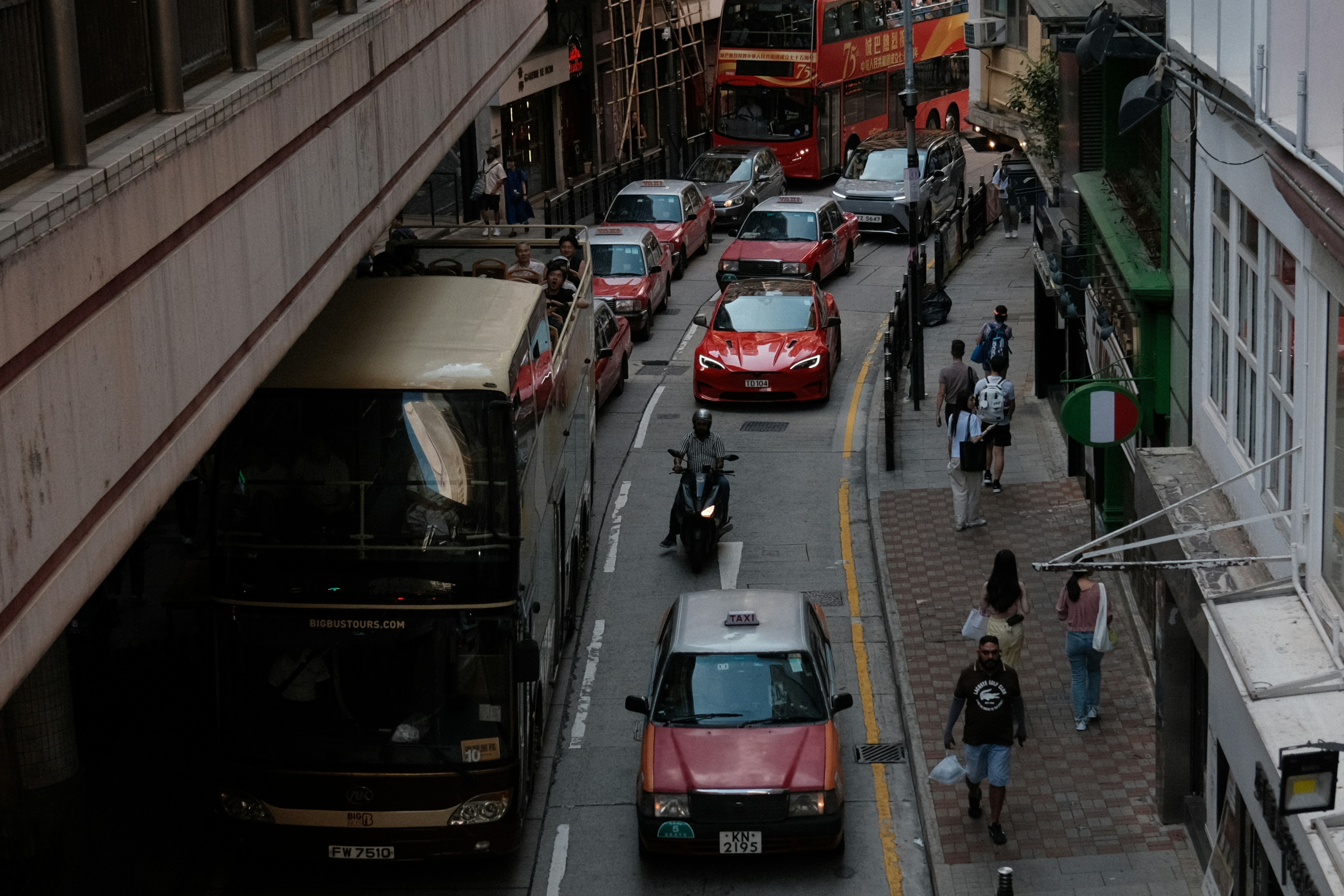 Busy city street with traffic and pedestrians.