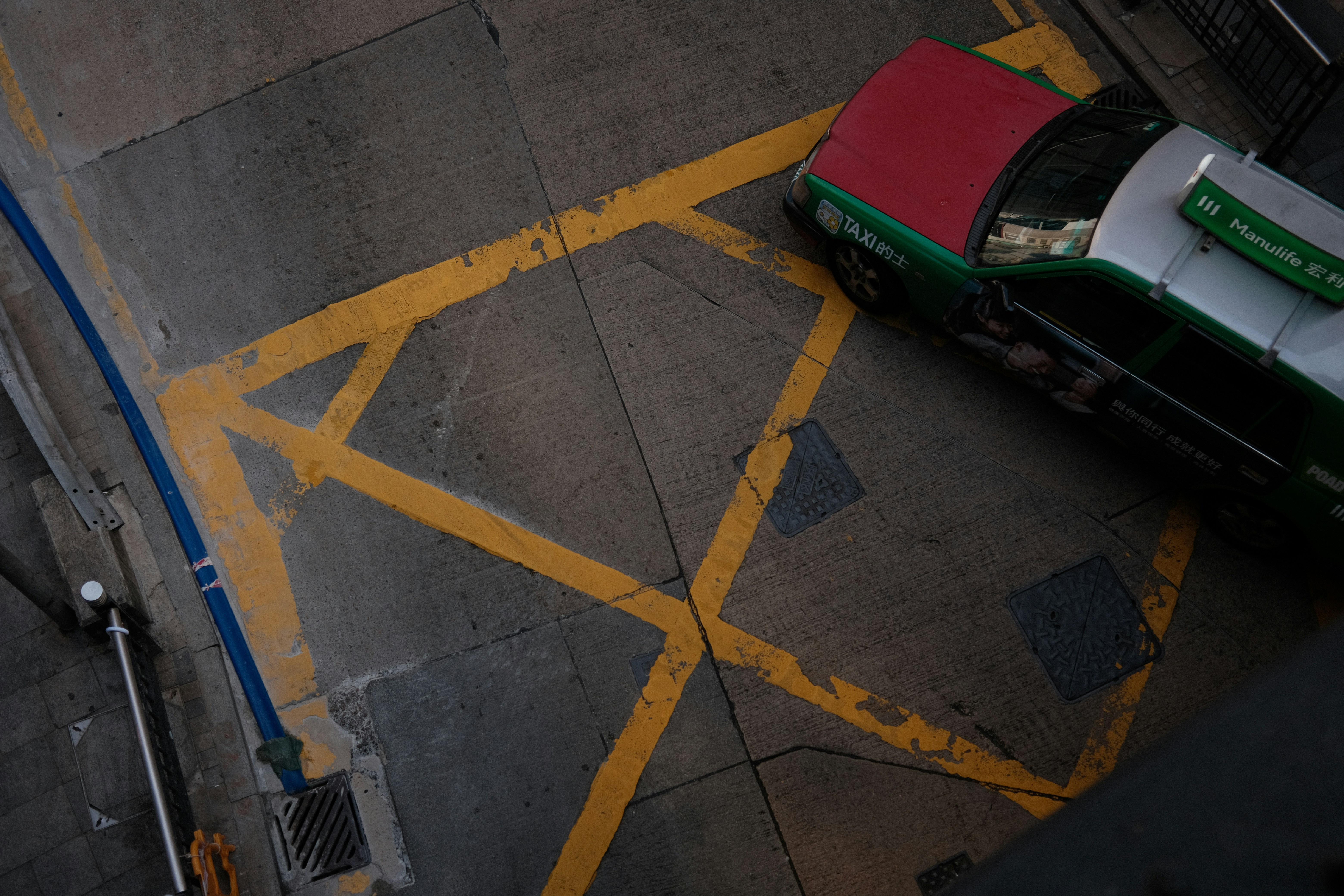 Yellow lines on asphalt with a taxi