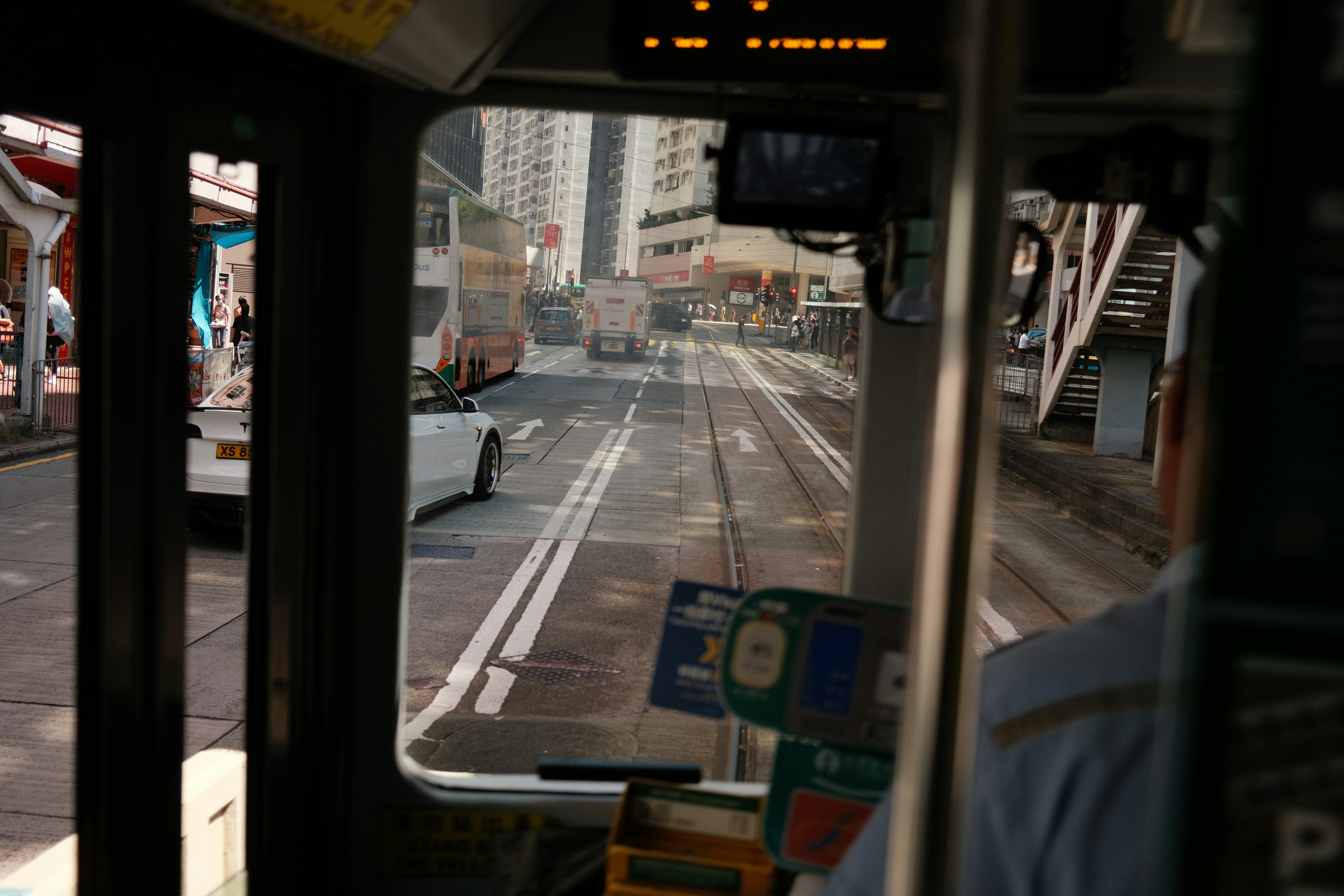 View from tram through city street with buildings