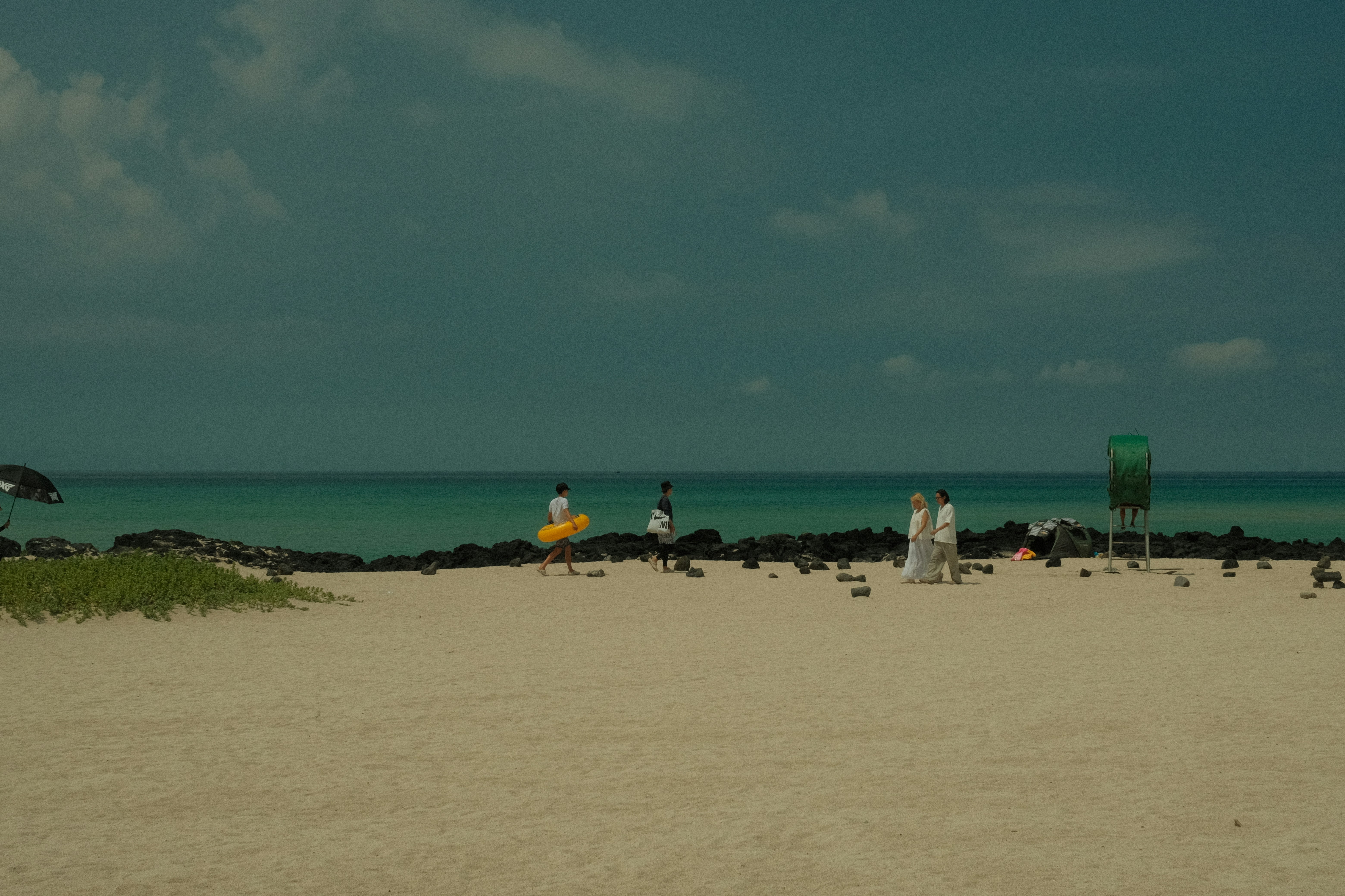 People enjoying a sunny day at the beach.