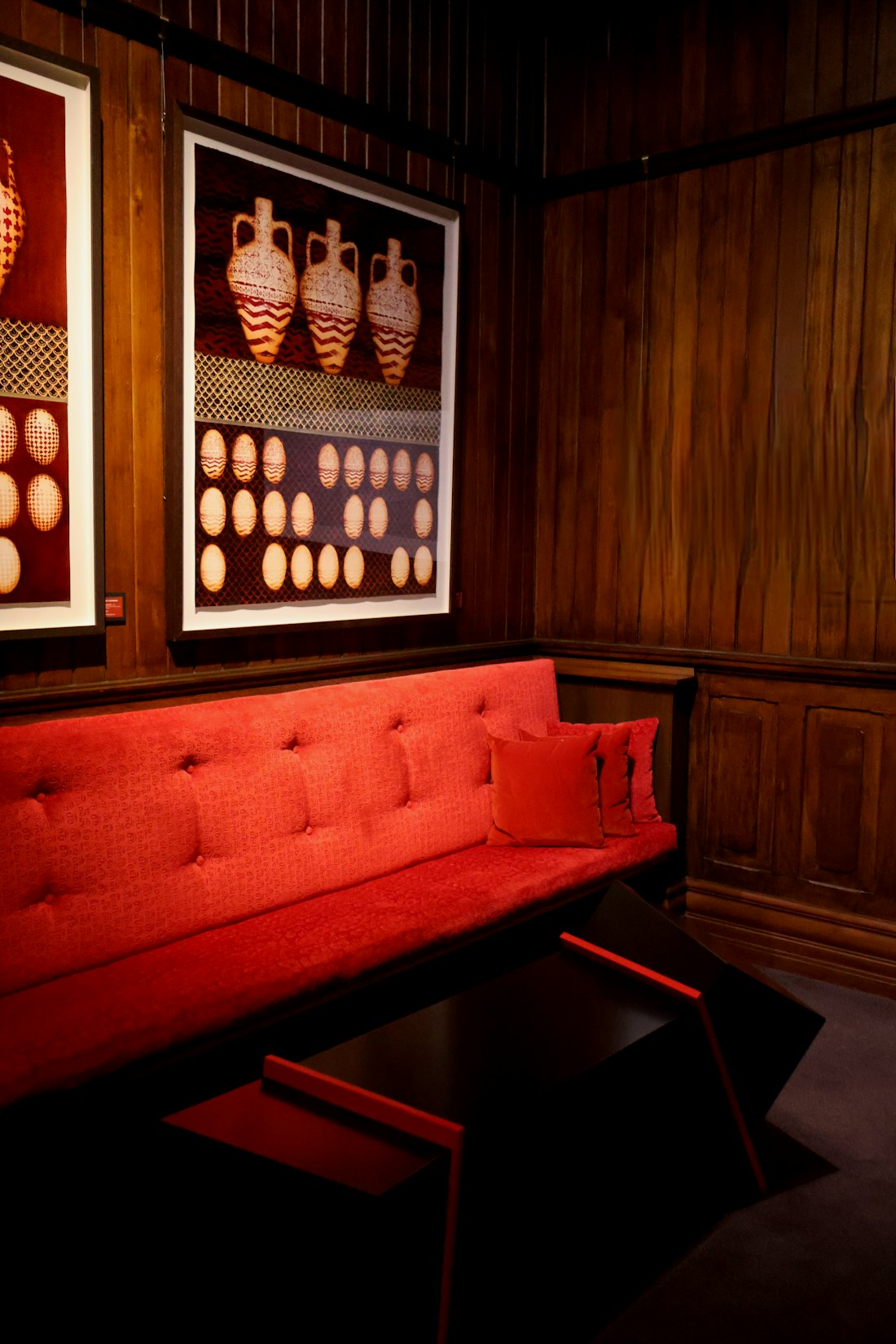 Orange sofa against a warm red wall