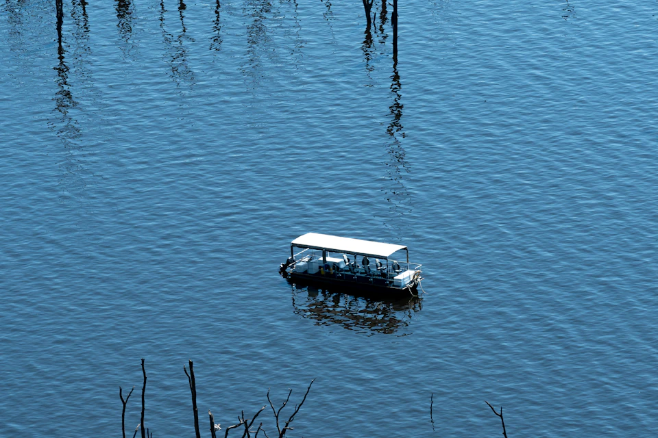 Tour boat crossing a calm blue lake