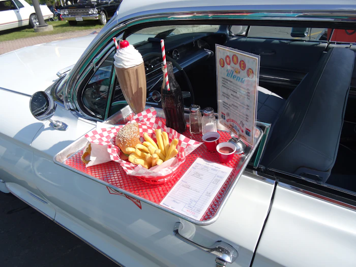 Tray with a burger, fries and a chocolate shake