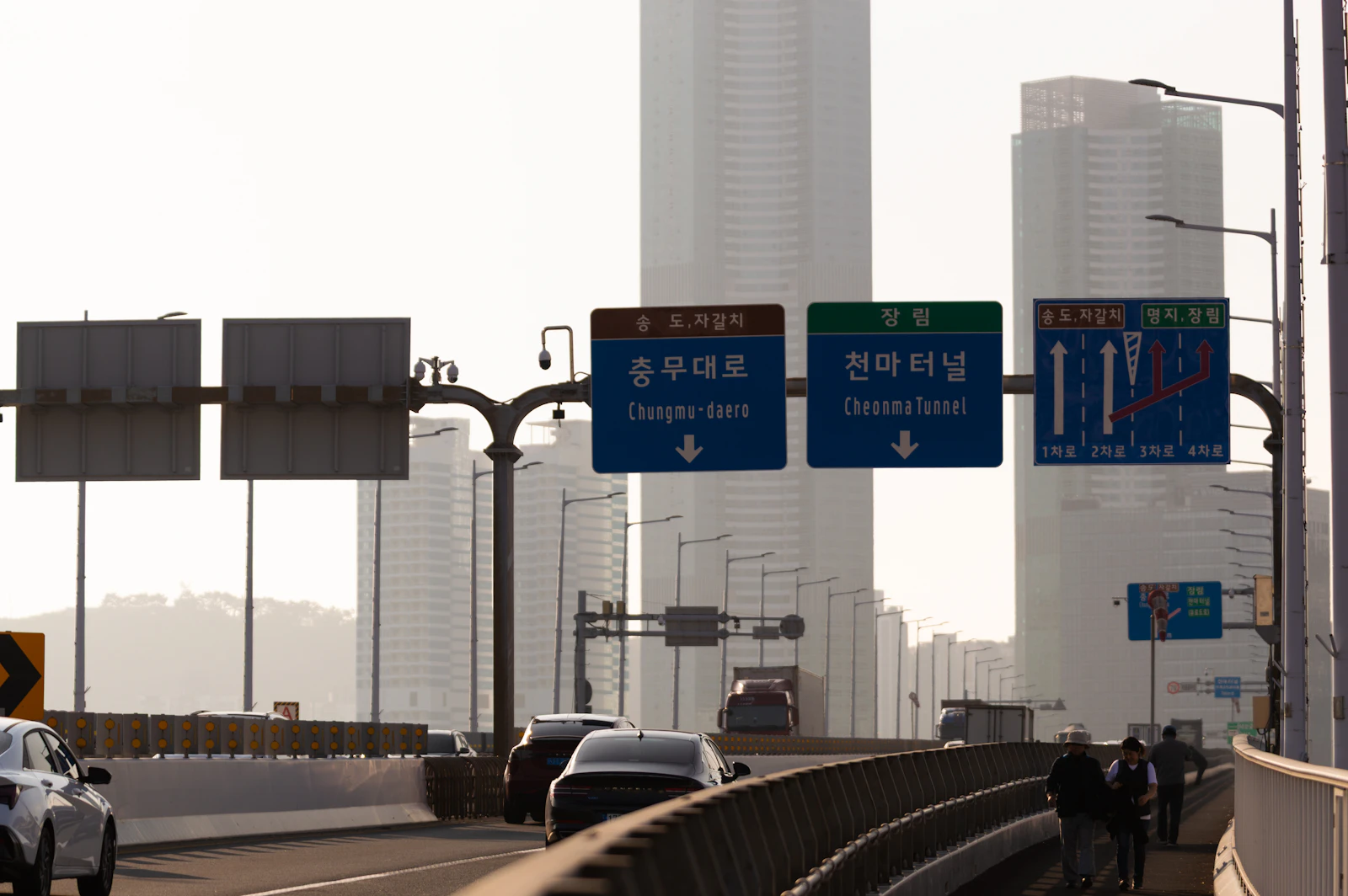 Korean direction signs above an urban highway in Busan