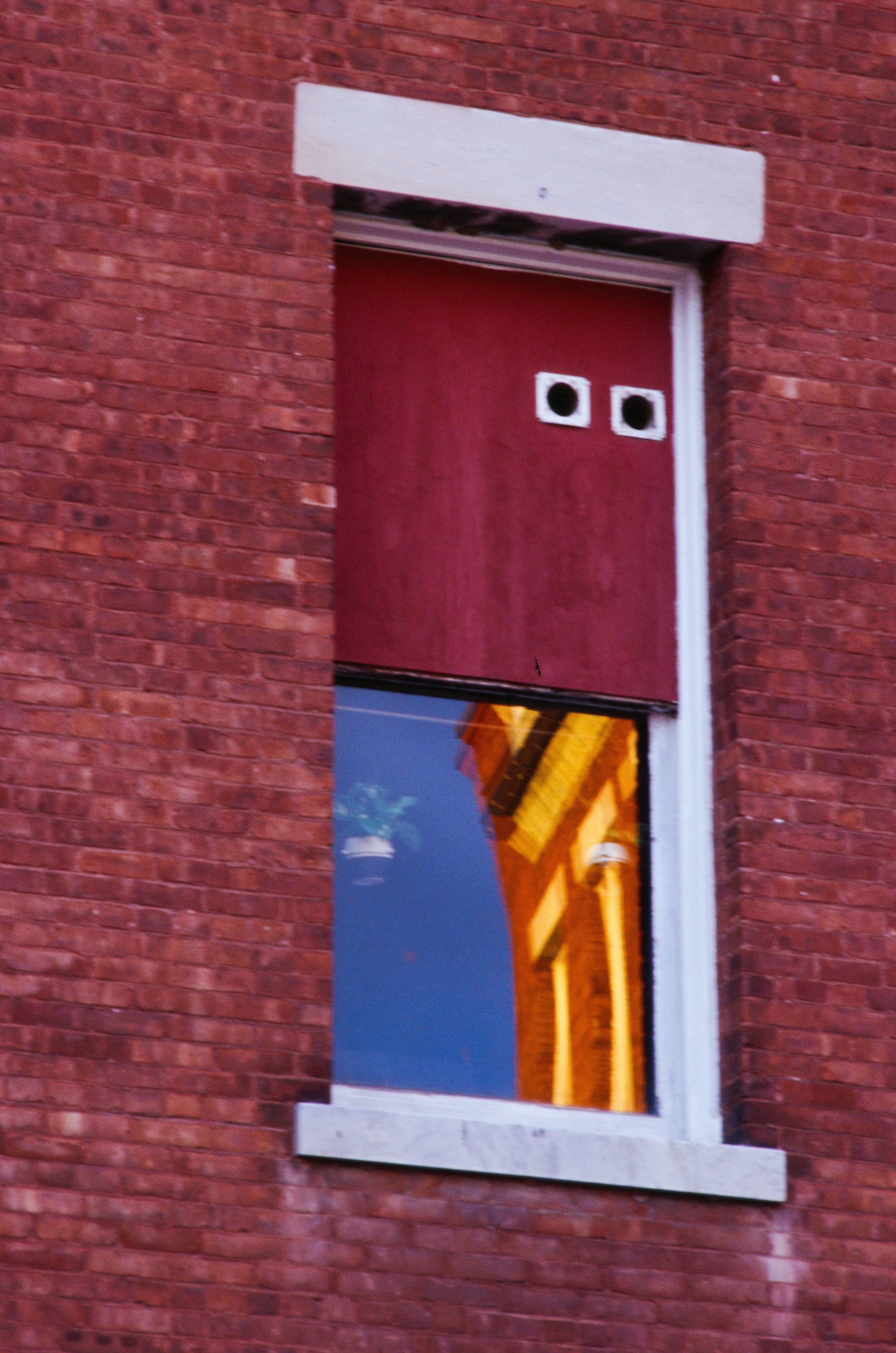 Red window blind with two square openings