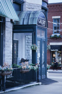 Edgewater gallery entrance with decorative plants and signage.