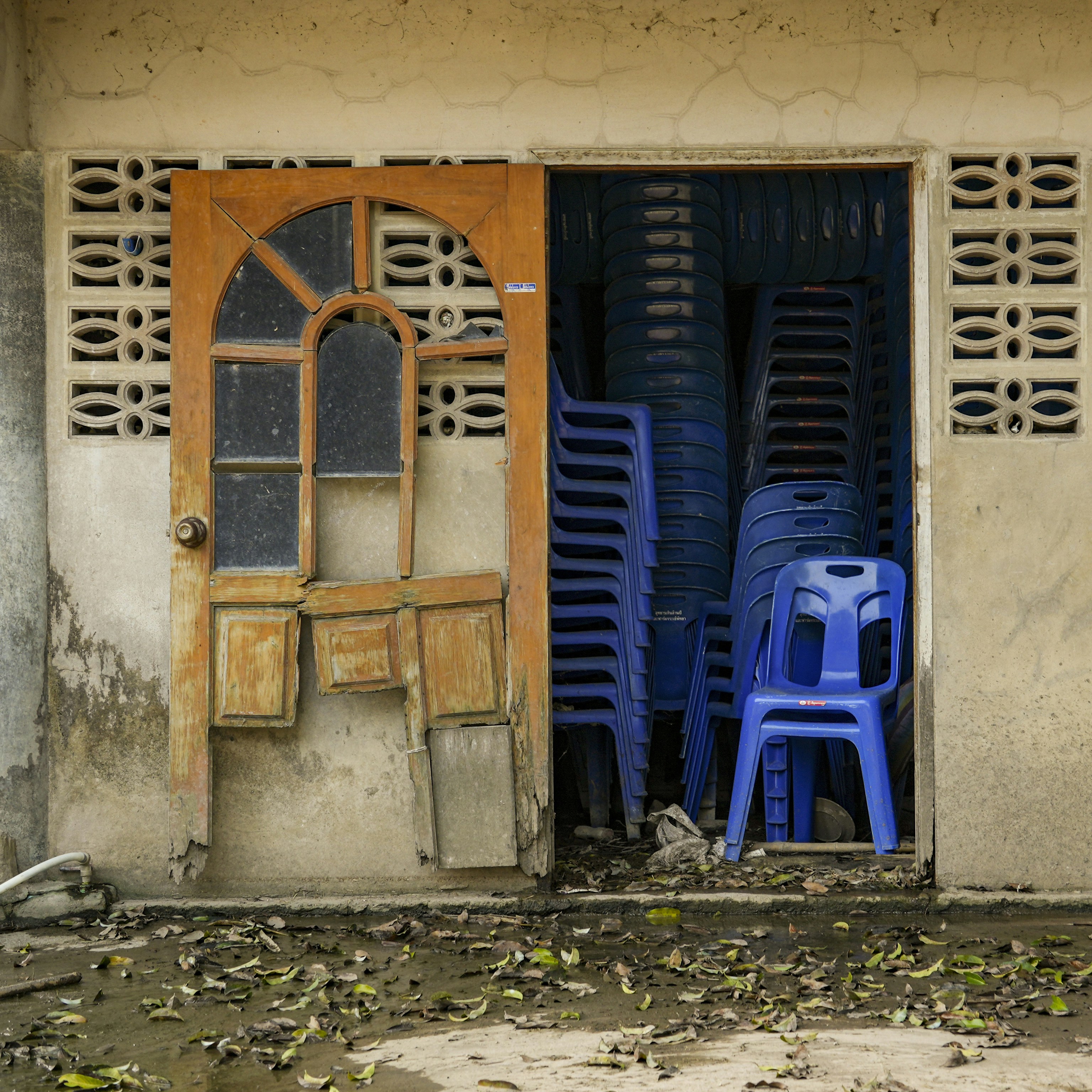 Stack of blue chairs in an open doorway