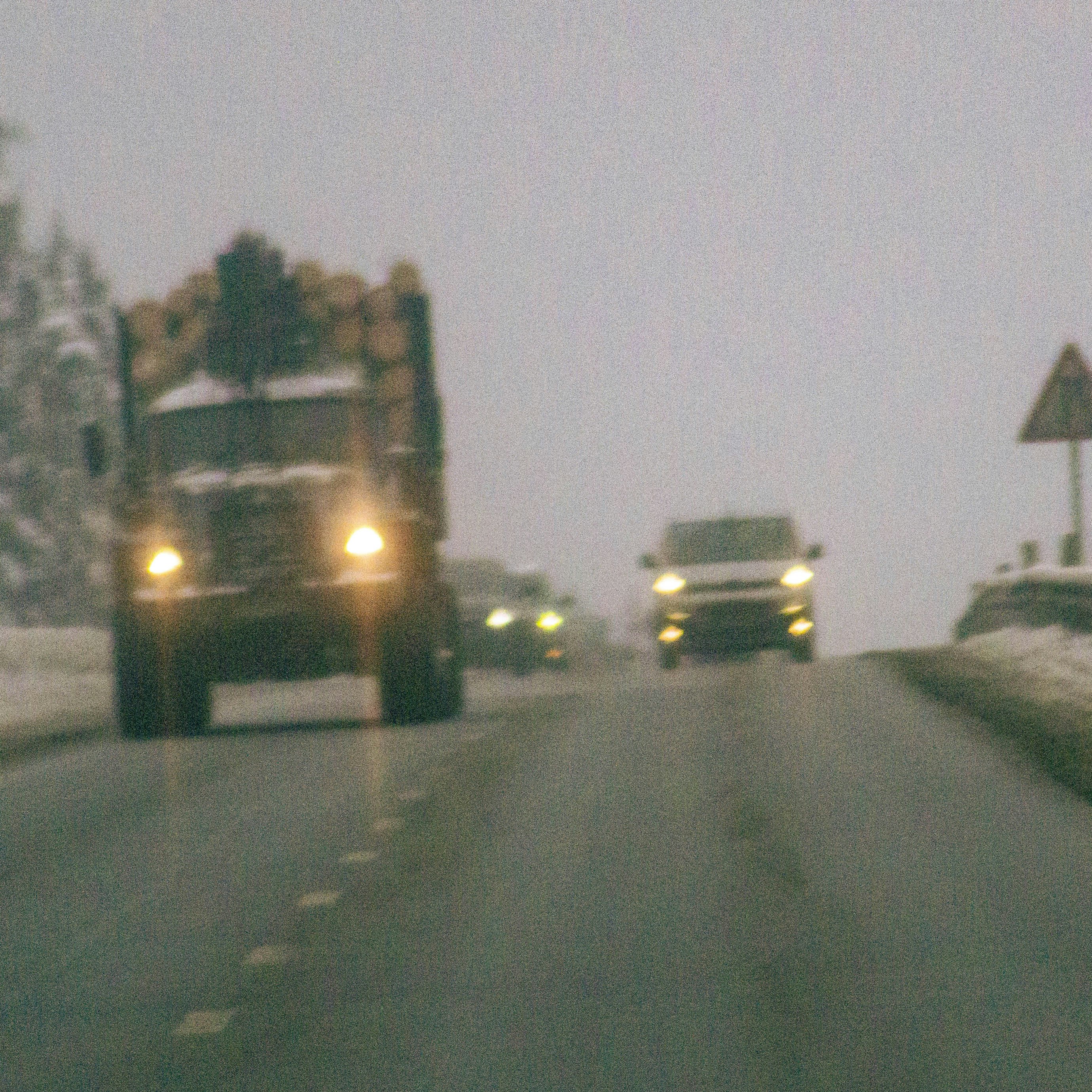 Truck and cars driving on a snowy road