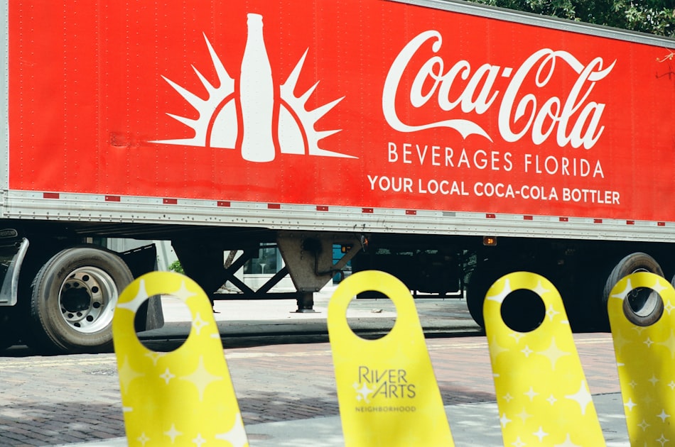 Coca-cola truck with yellow barriers in foreground