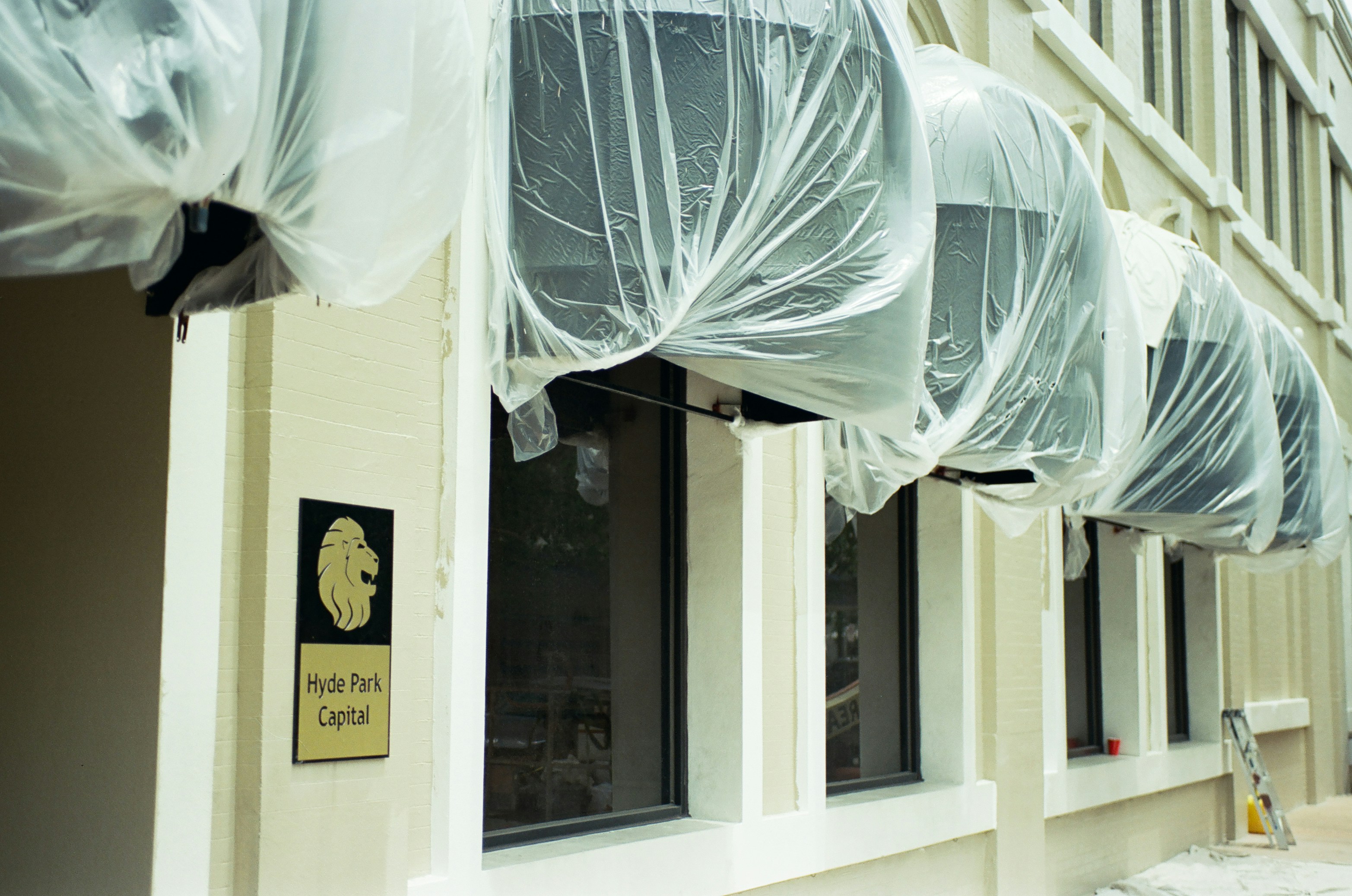 Building awnings covered in plastic sheeting
