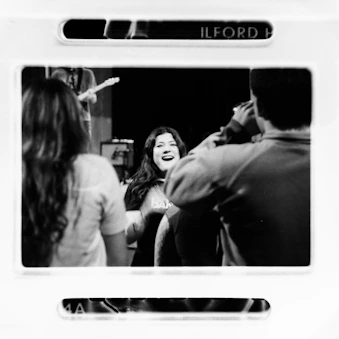 Smiling woman in audience watches a band perform