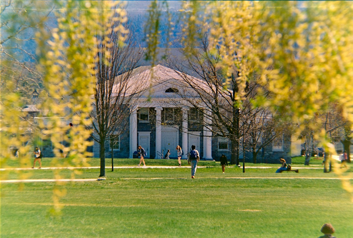 A college campus with a columned building, trees, and grass, ideal for a campus visit to explore college tour tips.