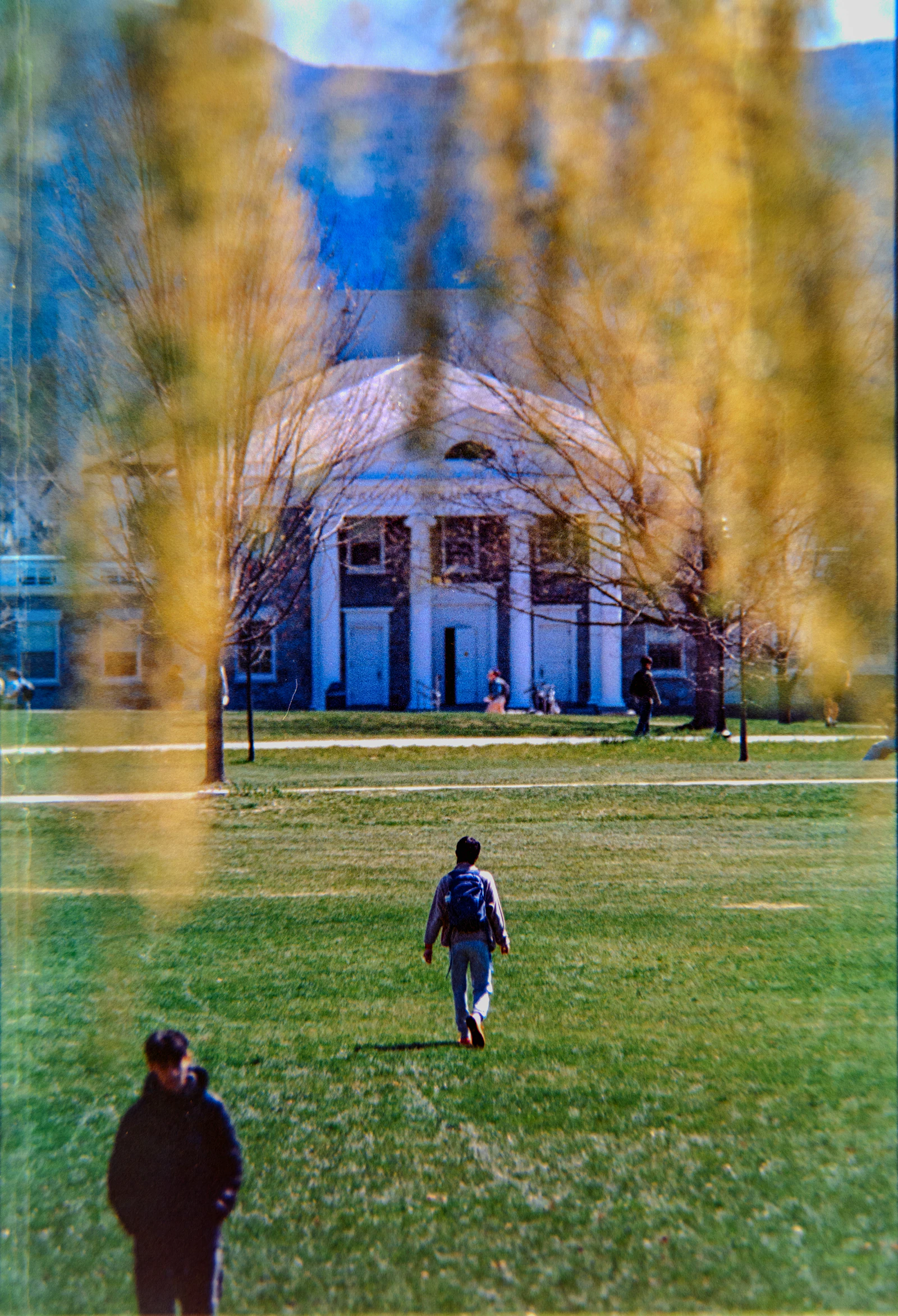 Students crossing the campus lawn towards the academic block