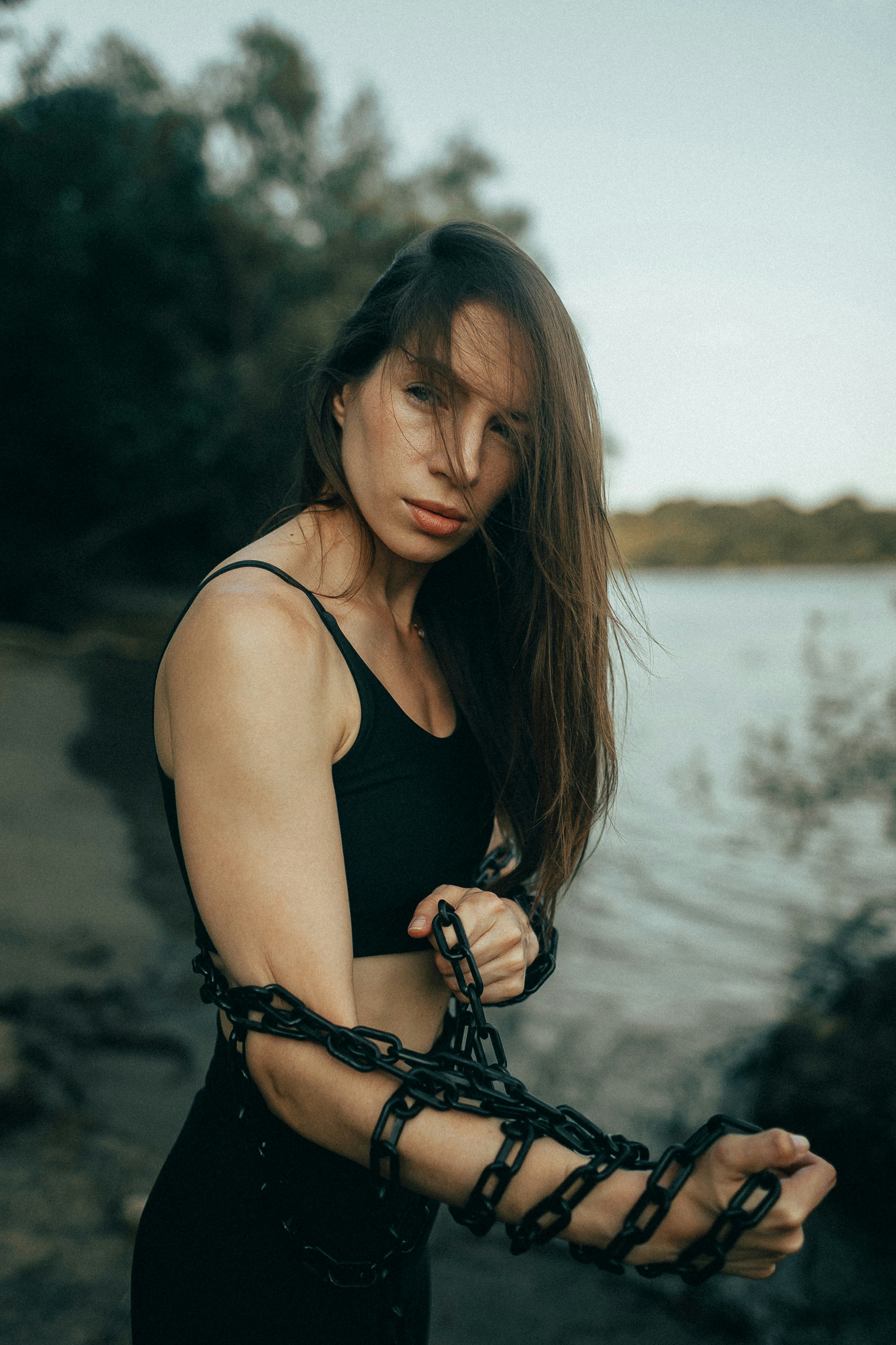 Woman with chains wrapped around her arms