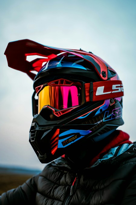 Close-up of motocross helmet with mirrored goggles and strap — trail goggle topic object