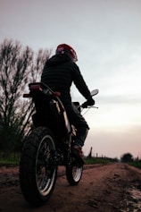 Rider on dirt bike on a rural road at dusk