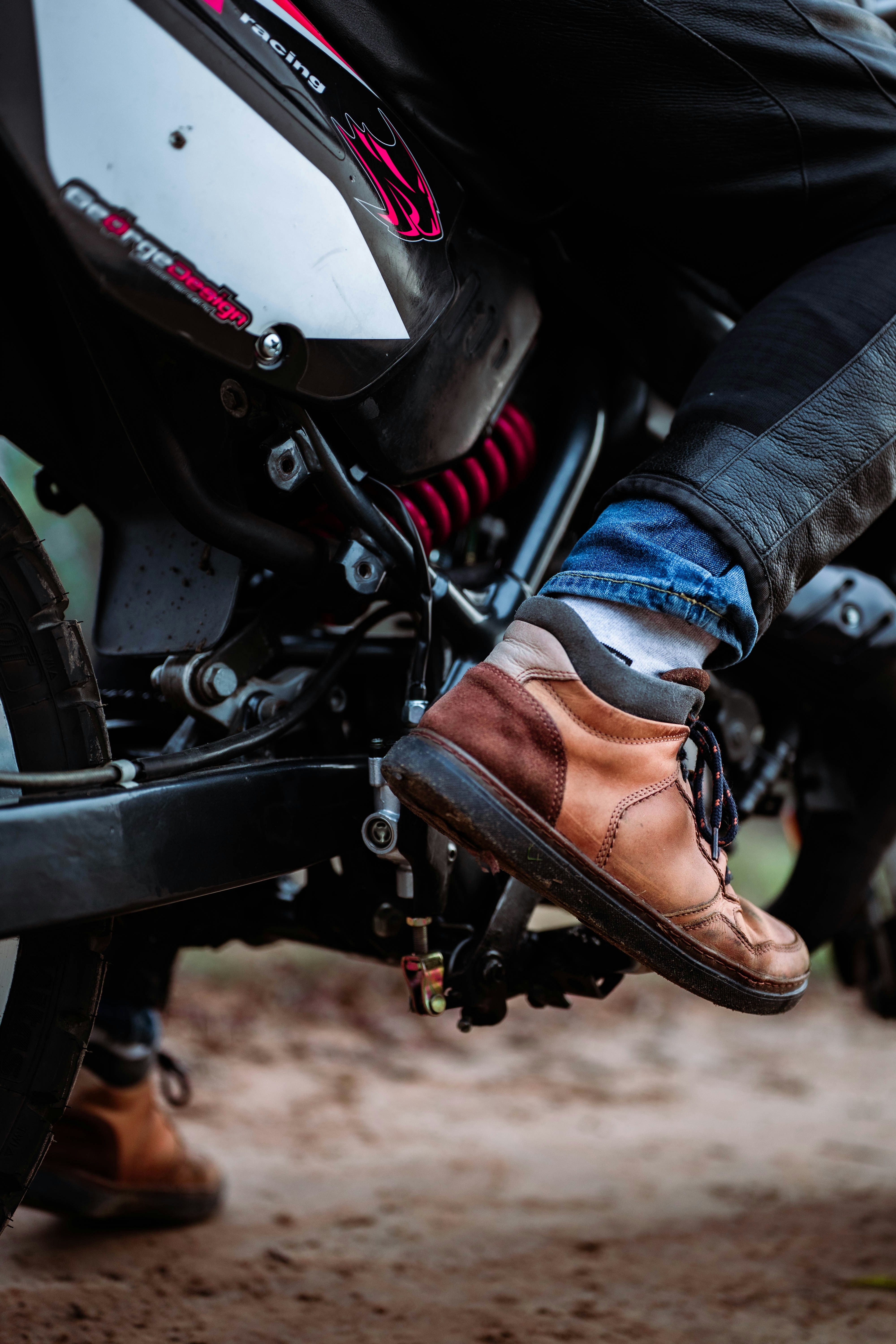 Person wearing brown boots on a motorcycle