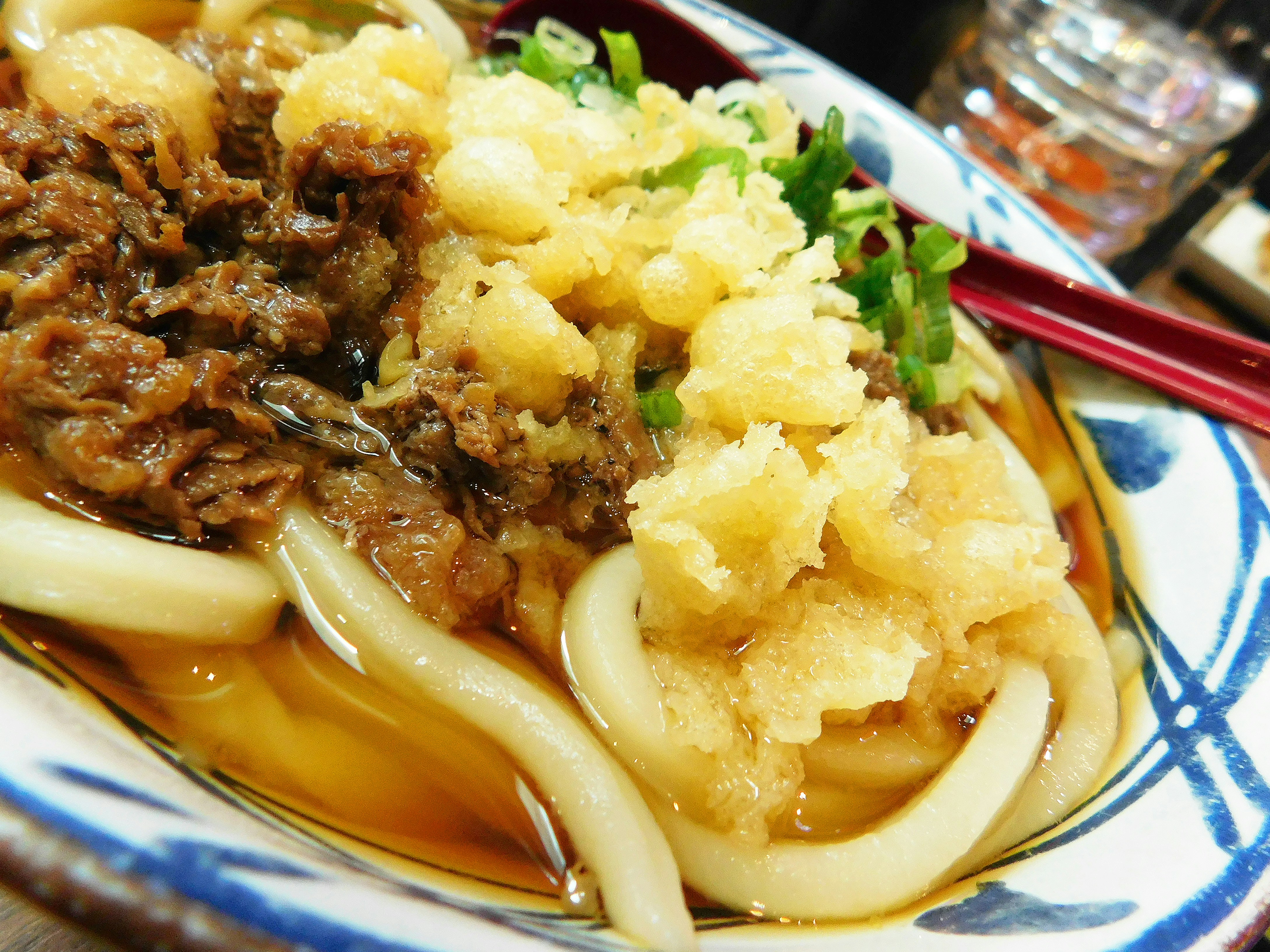 Udon noodles with beef and tempura in broth