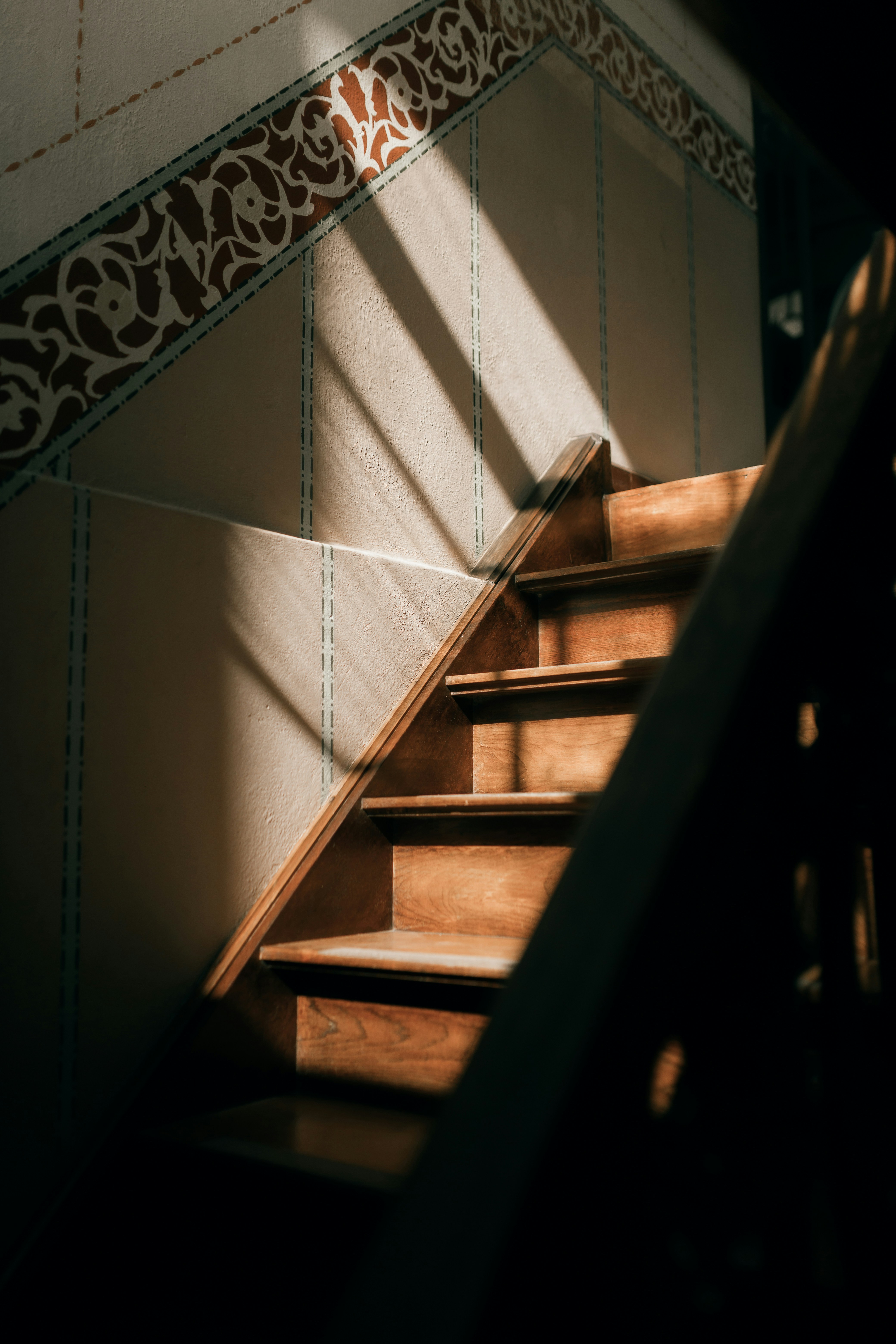Sunlight streams onto a wooden staircase.