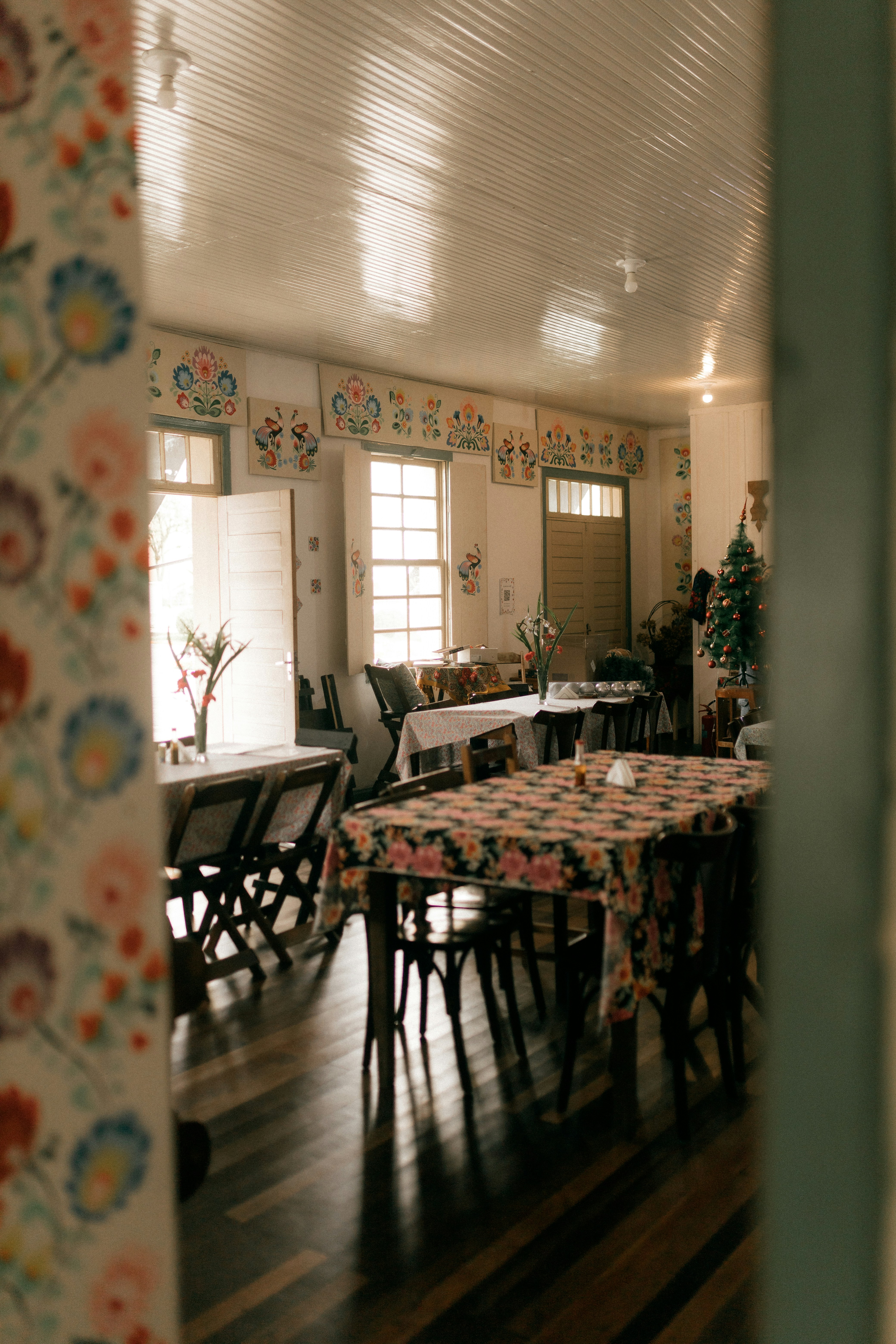 Dining room with floral tablecloths and decorated walls