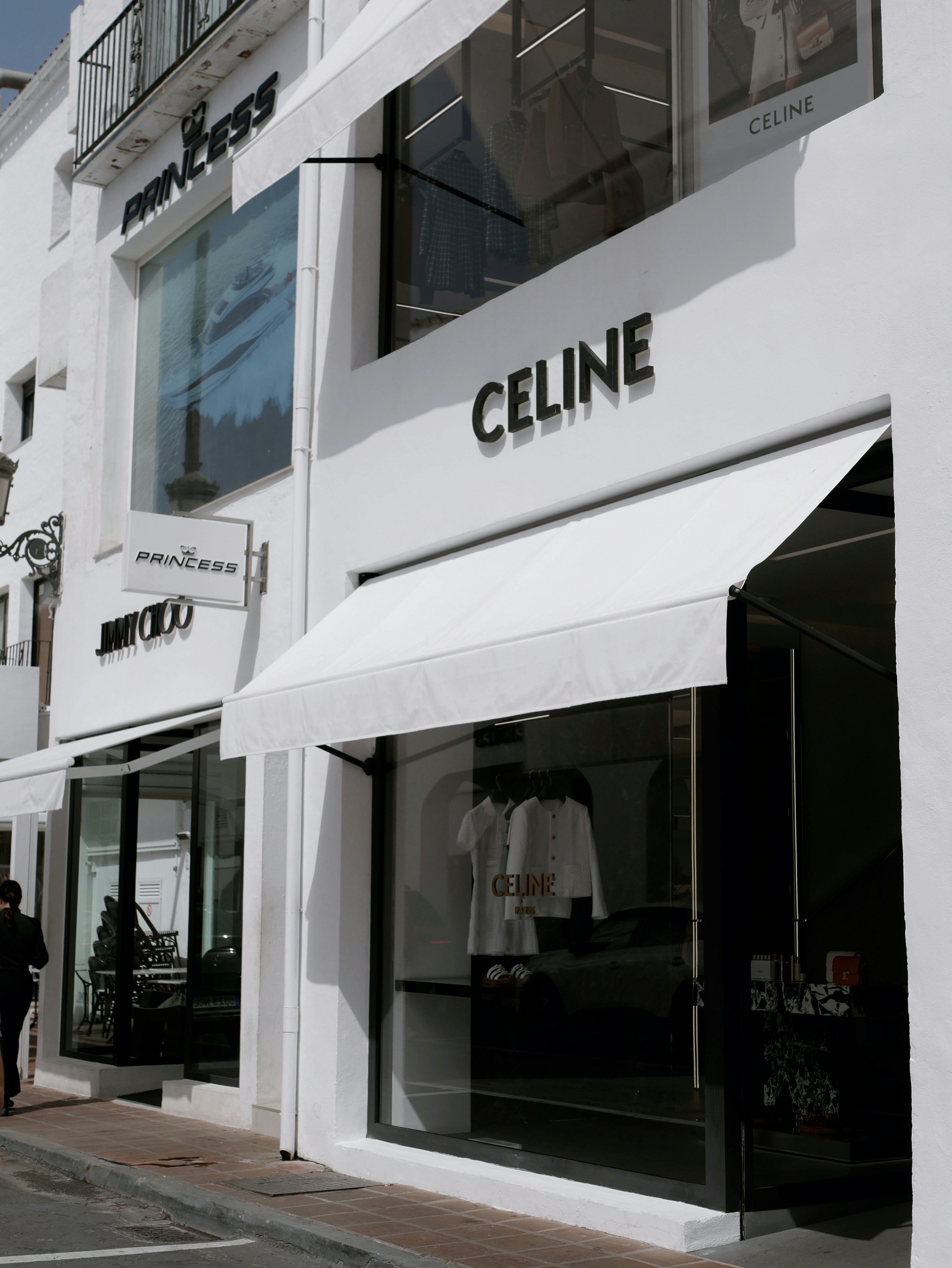 White storefronts for luxury brands celine and jimmy choo.