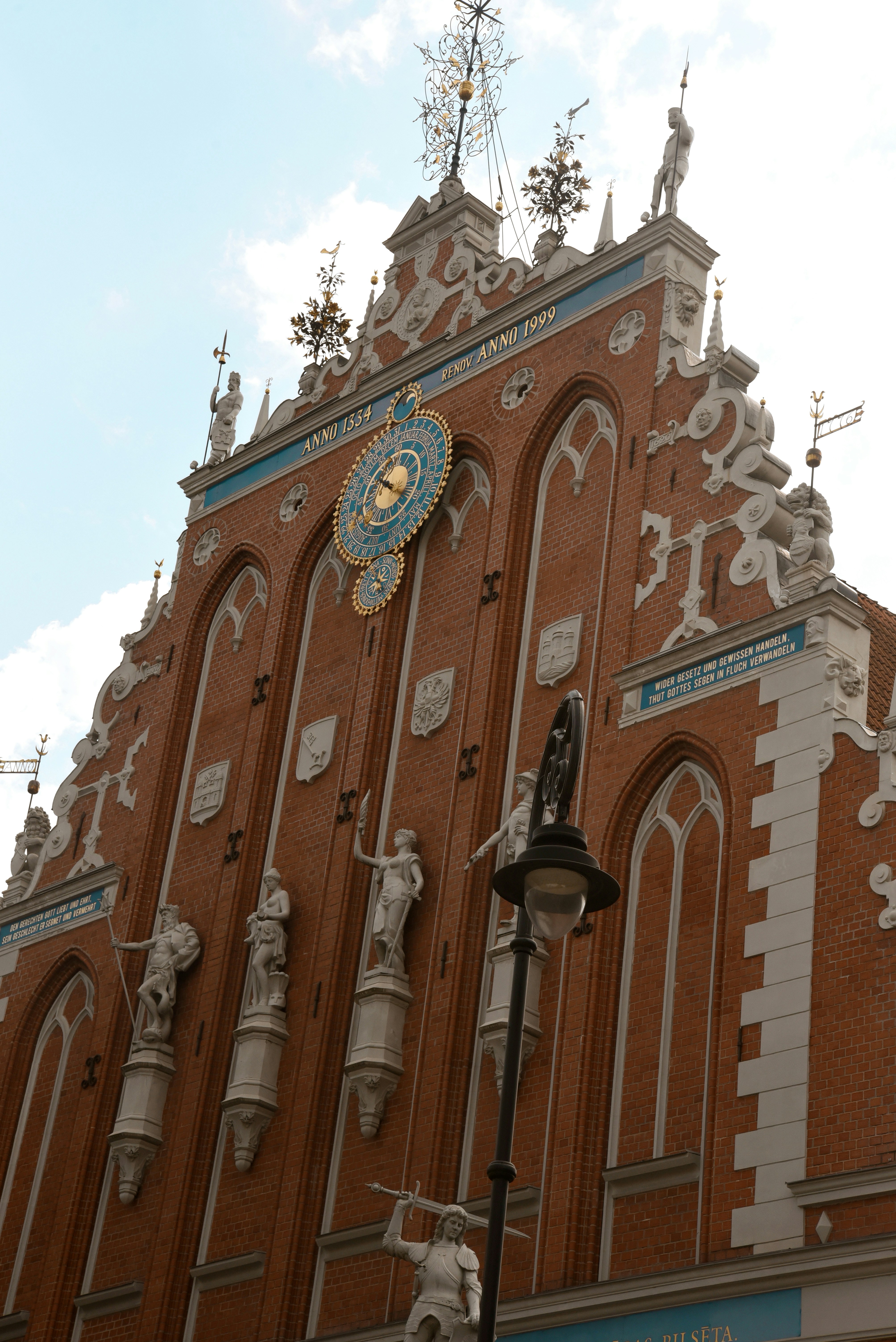 Ornate brick building with statues and clock