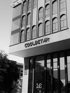 Modern building facade with arched windows and signage.