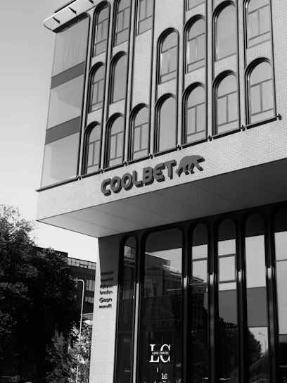 Modern building facade with arched windows and signage.
