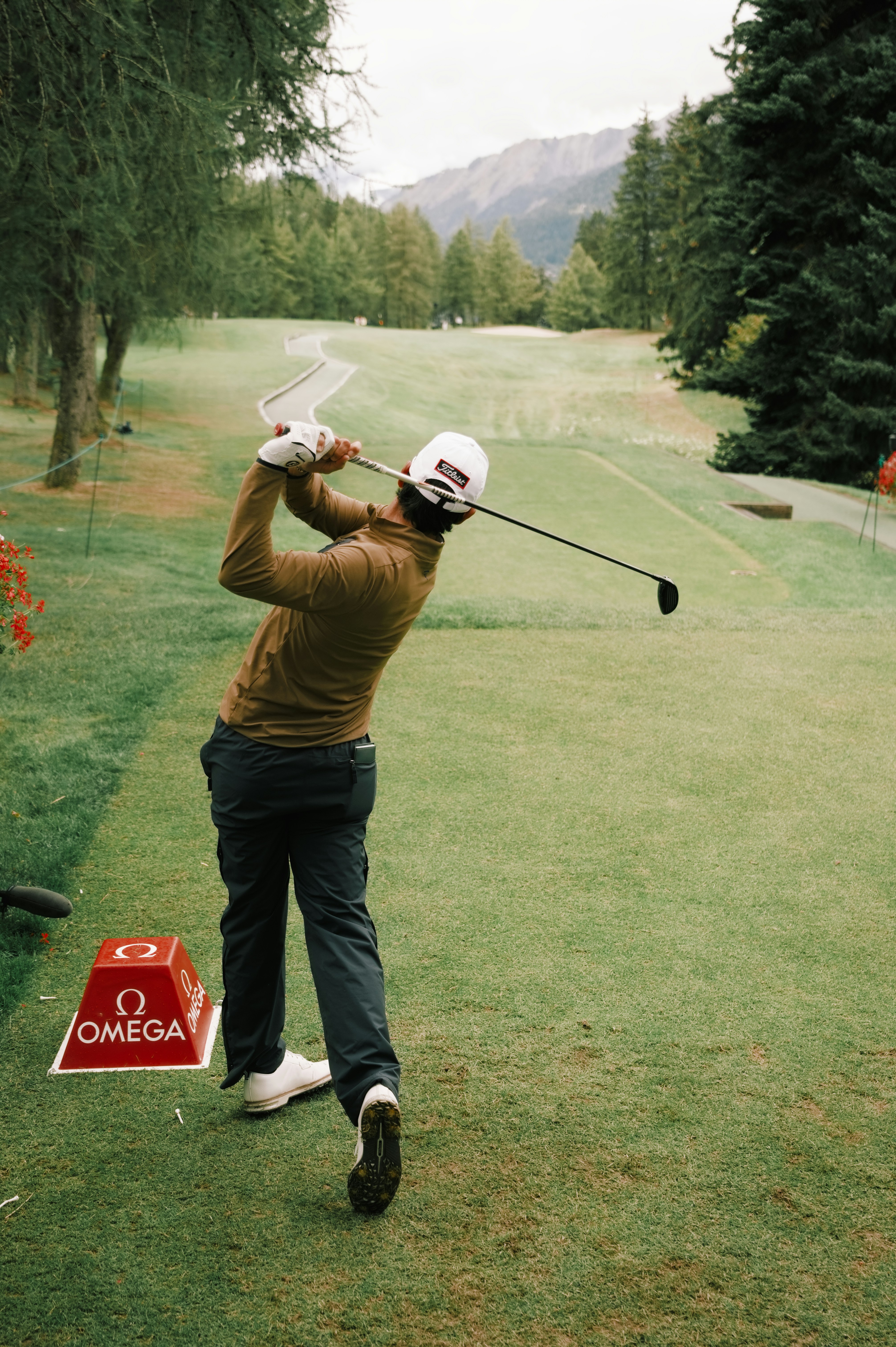 ゴルファーがグリーンコースでクラブを振る