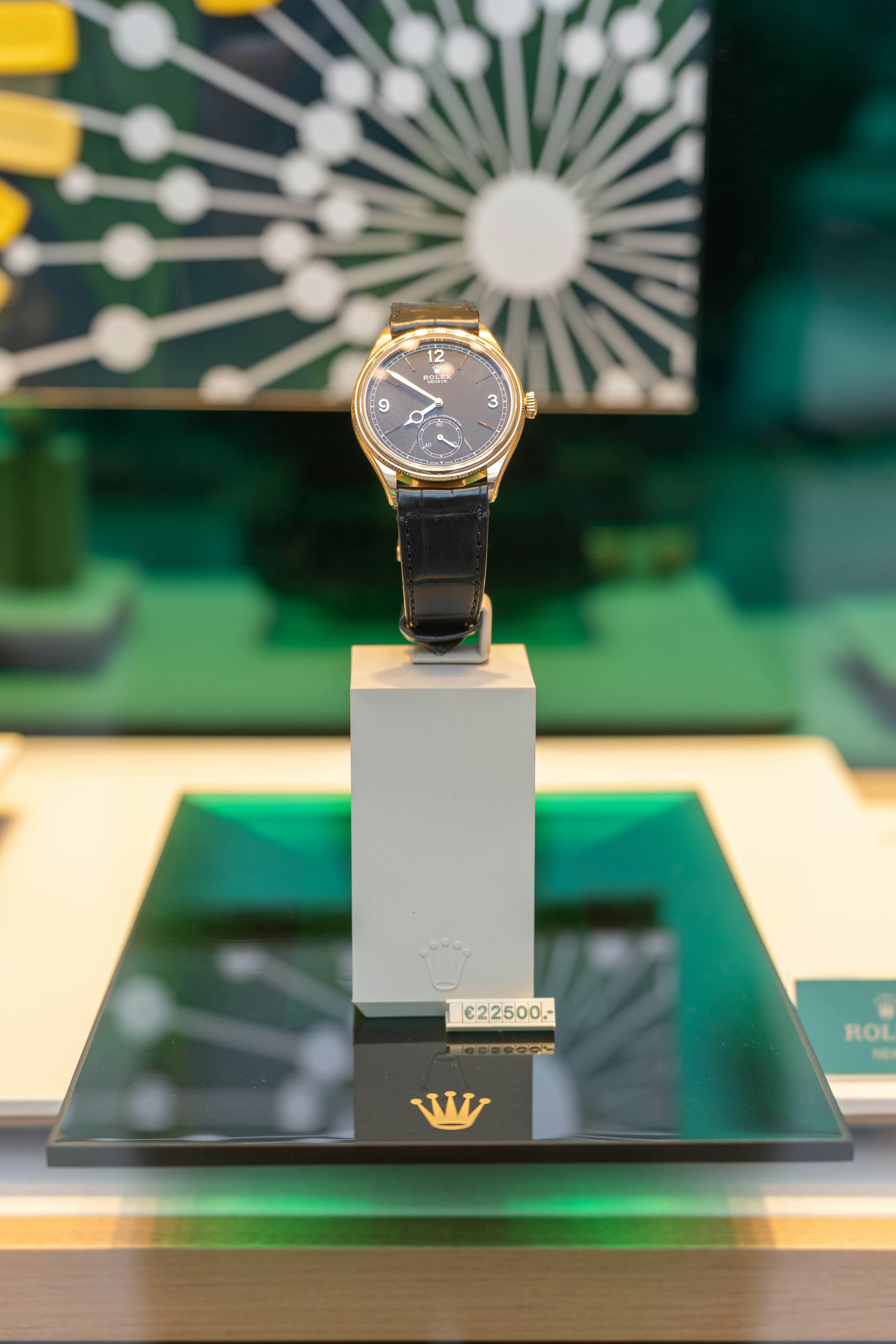 Gold wristwatch with black leather band displayed