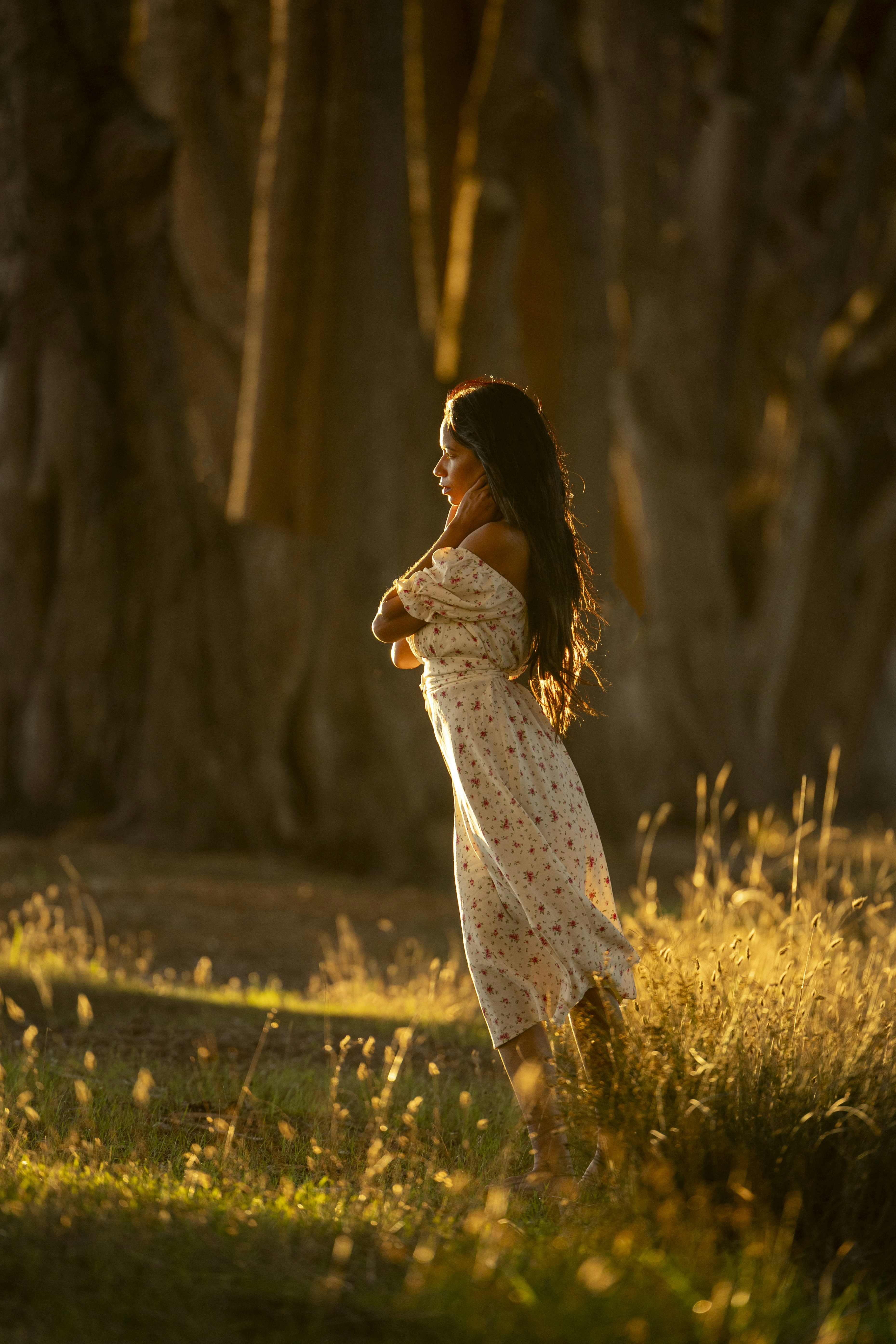 Person in a flowing dress standing in warm afternoon light