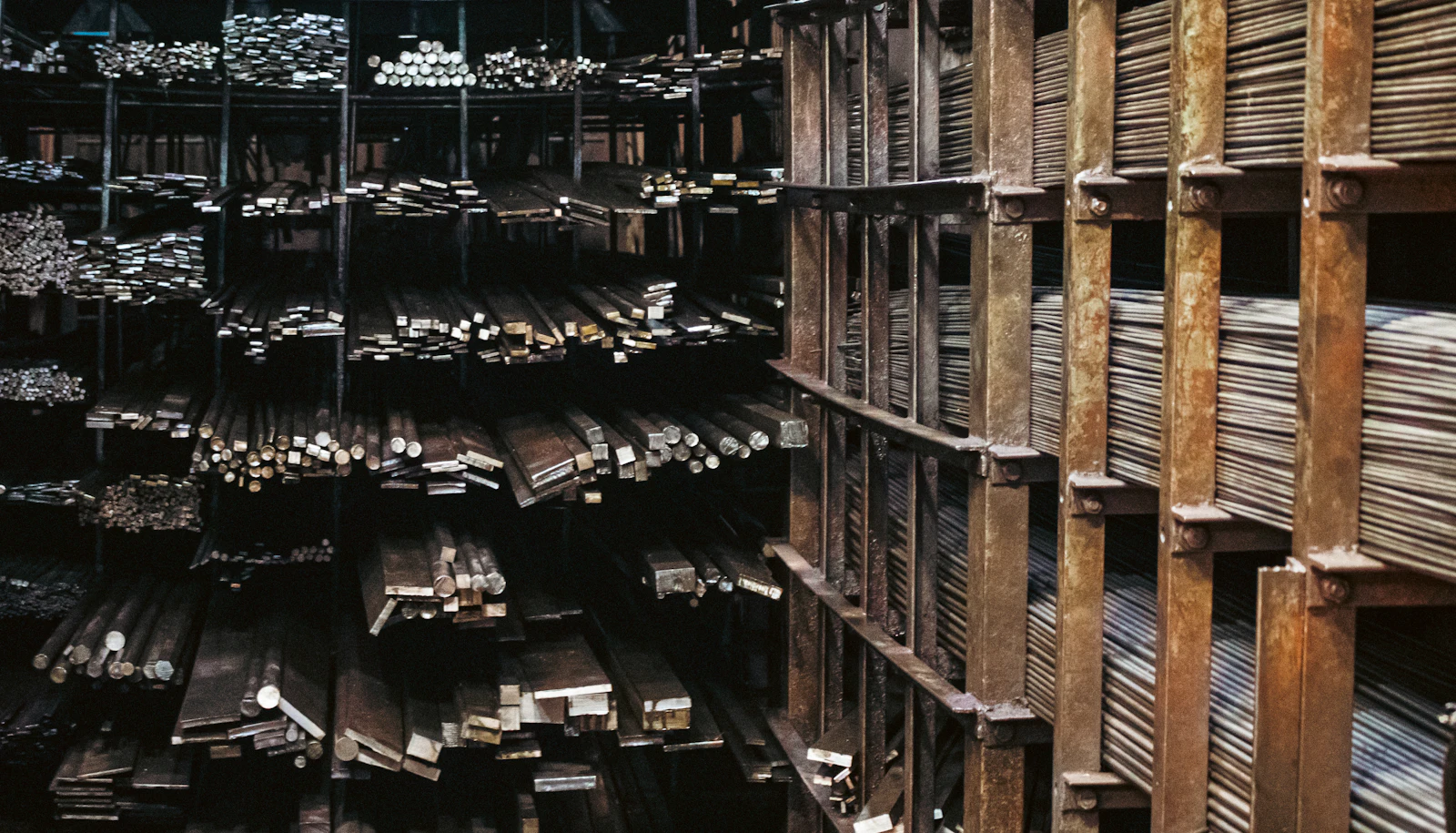 Steel shelving bays holding stacked bar and rod stock