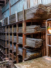 Metal rods stacked in a warehouse storage