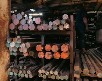 Metal rods stacked on shelves in a warehouse.