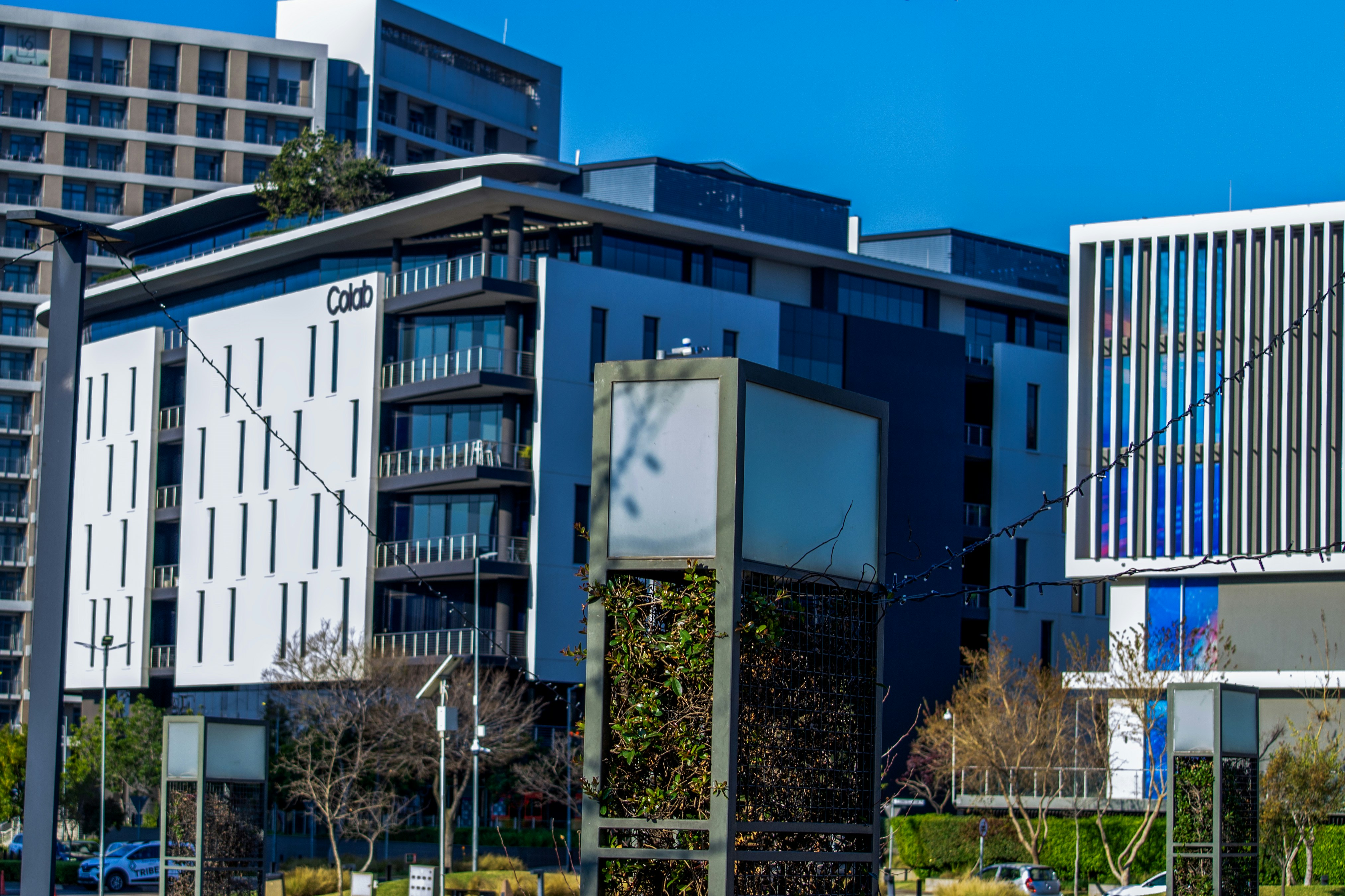 Modern buildings with glass and white facades under sky