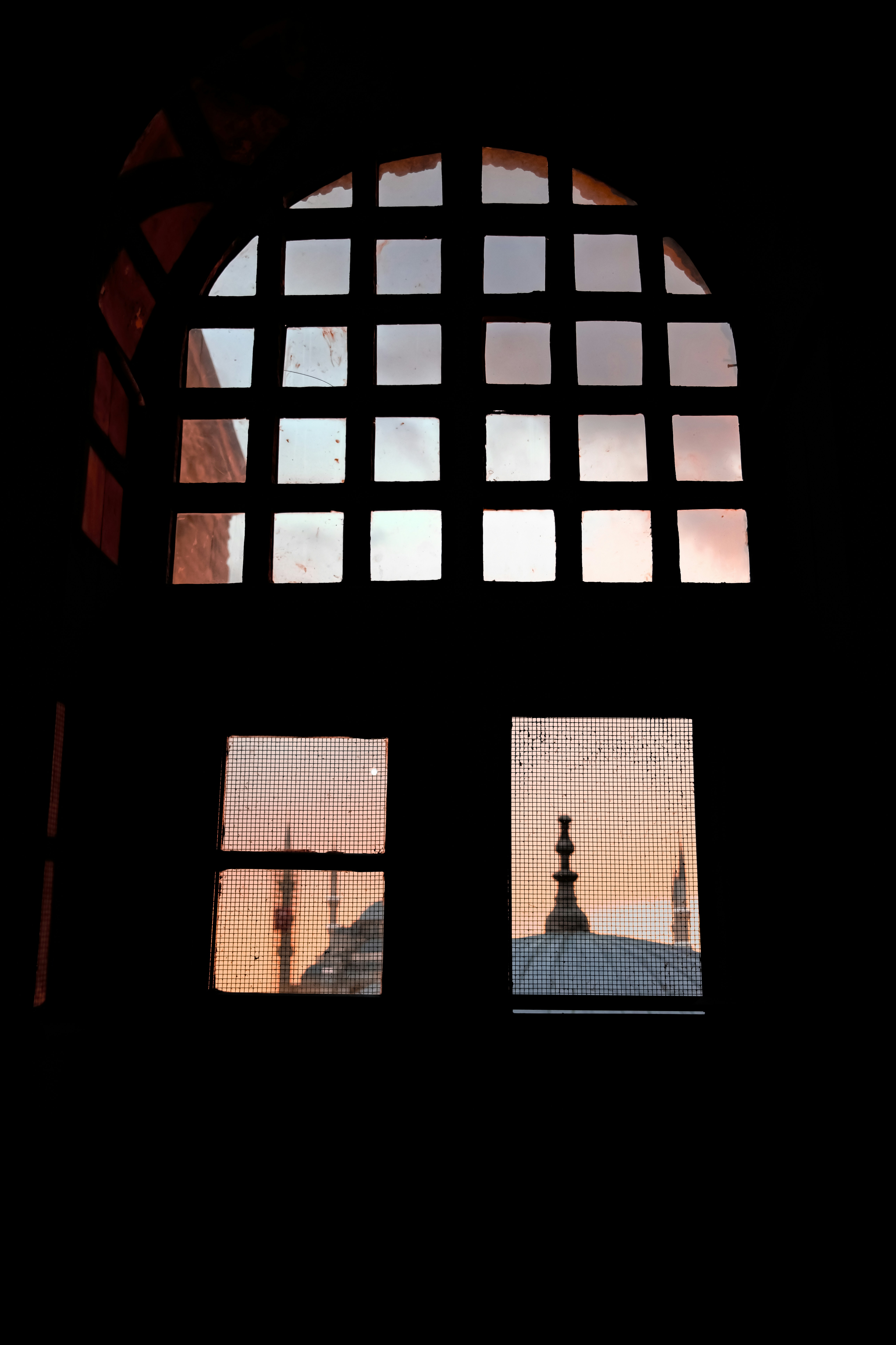 Mosque minarets and dome seen through window