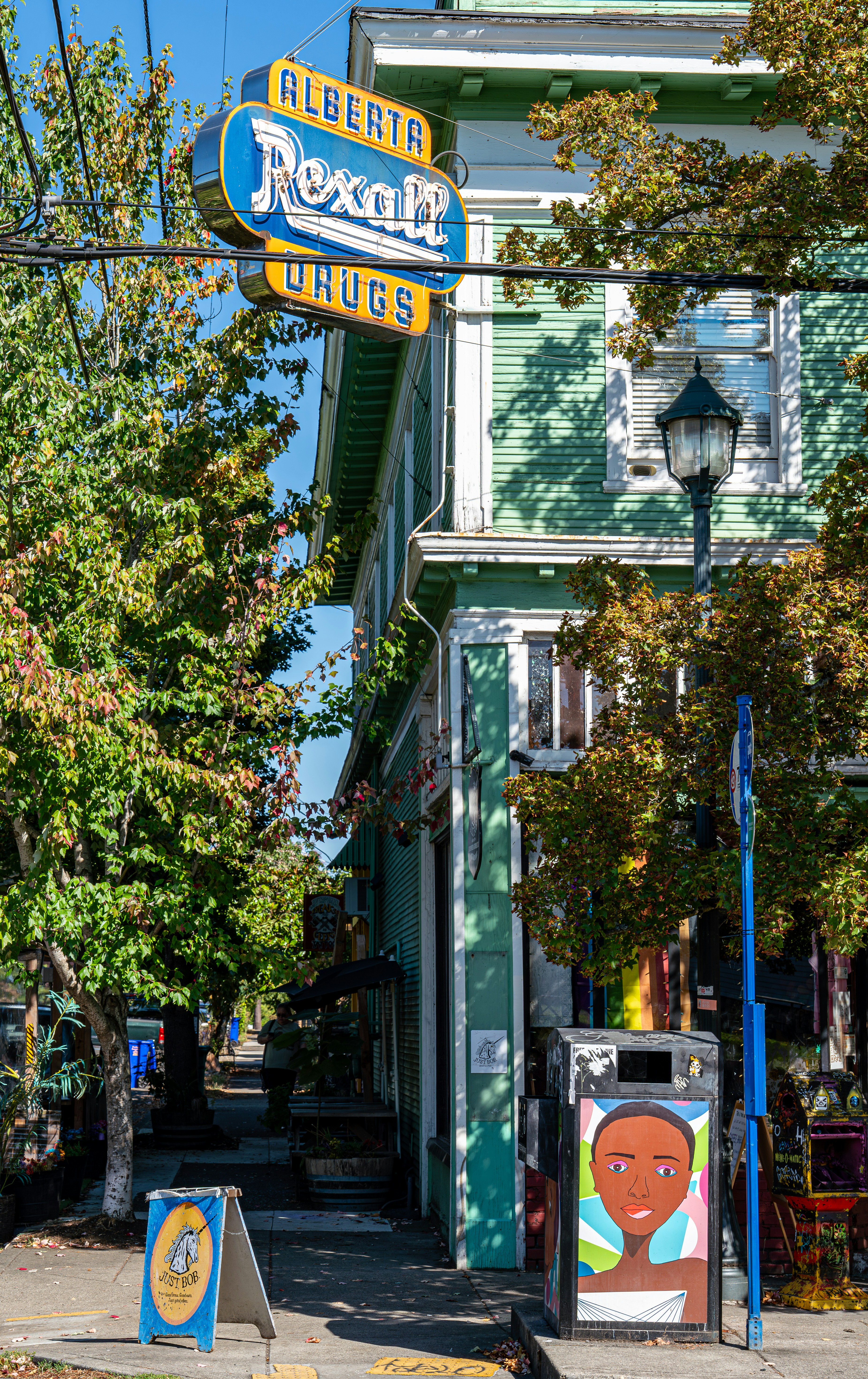 Prédio Alberta Rexall Drugs com árvores e arte de rua