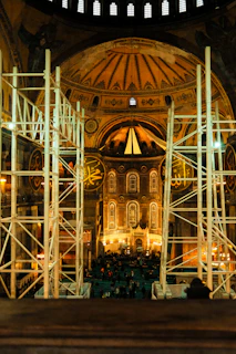 Interior of hagia sophia with scaffolding and people below