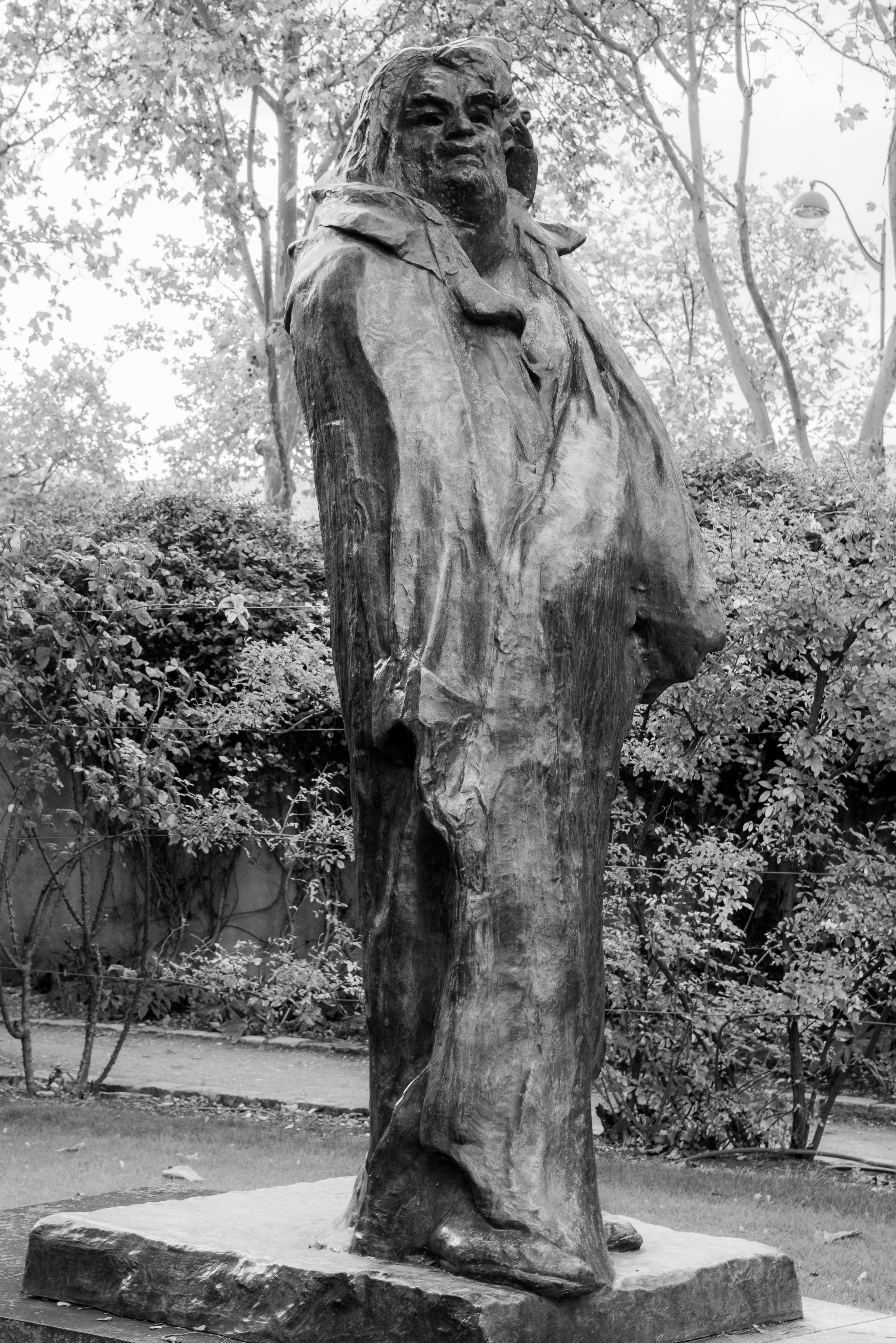 A tall, imposing bronze statue of a person.