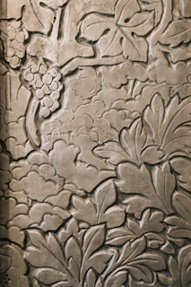 Intricate relief carving of leaves and grapes