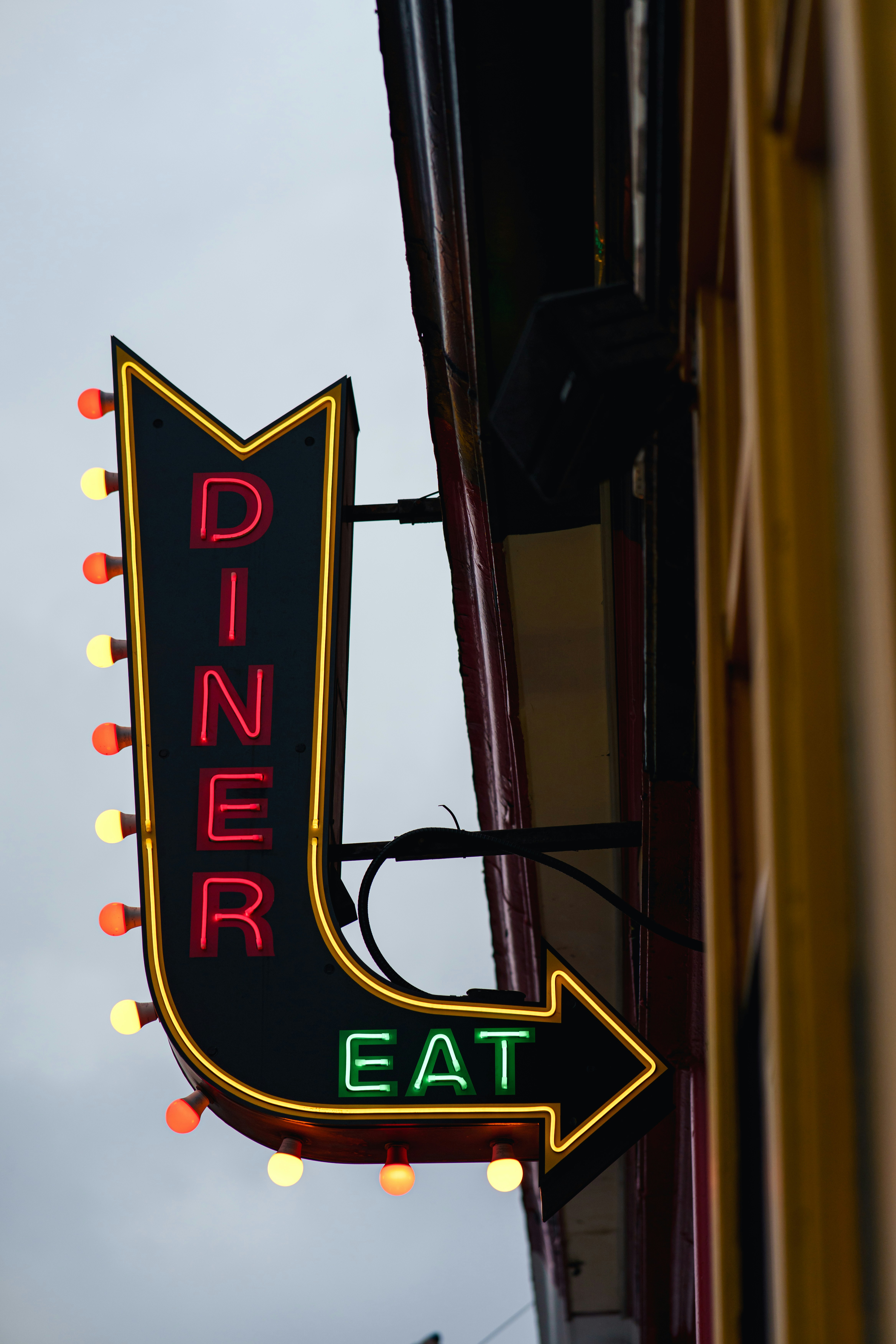 Neon diner sign with arrow pointing right