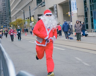 Man in santa costume running a race