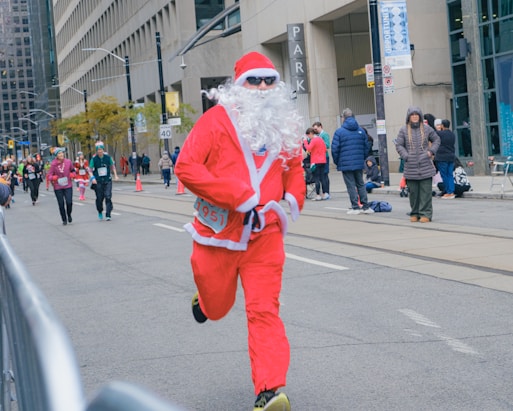 Man in santa costume running a race