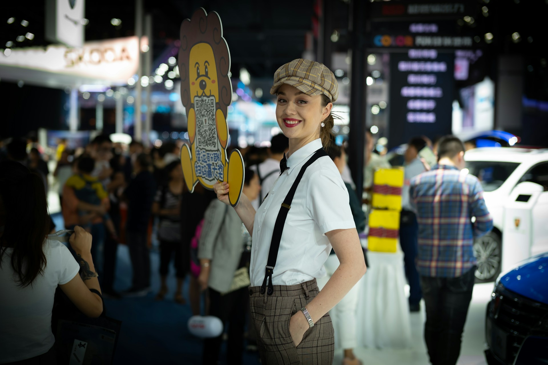 Woman in vintage outfit holding a cutout at an event